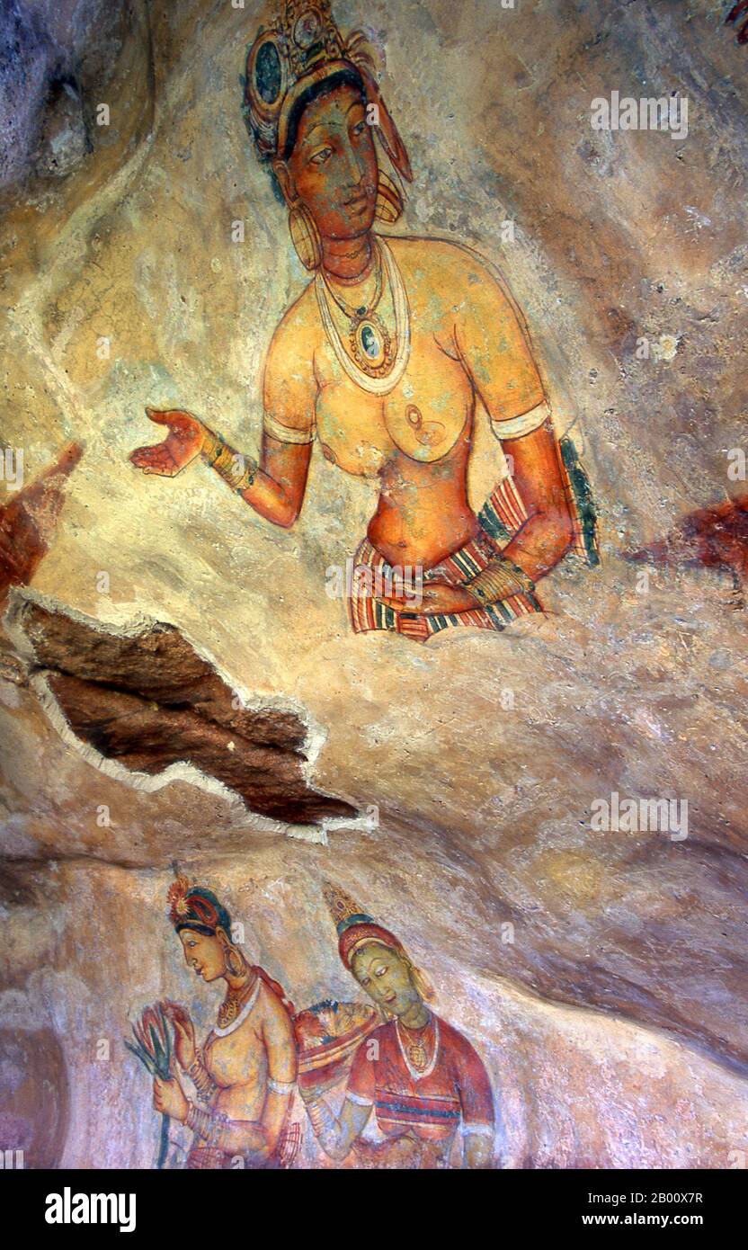 Sri Lanka: Sigiriya's 'Cloud Maidens' adorn the rock face high up over the surrounding countryside.  Sigiriya (Lion's rock) is an ancient rock fortress and palace ruin situated in the central Matale District of Sri Lanka, surrounded by the remains of an extensive network of gardens, reservoirs, and other structures. Sigiriya was built during the reign of King Kasyapa I (CE 477 – 495) and after his death it was used as a Buddhist monastery until the 14th century. Stock Photo