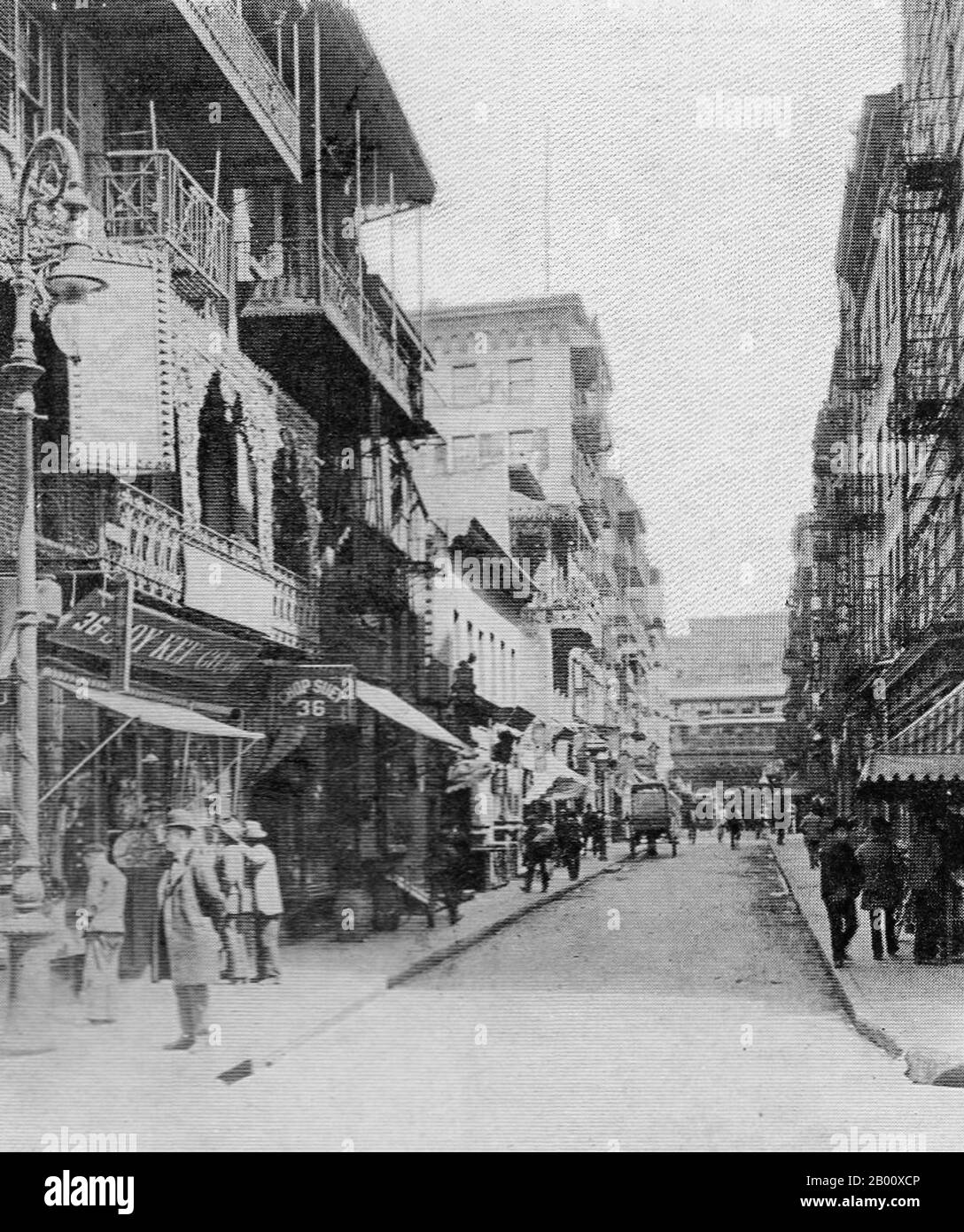 USA: Pell Street, New York Chinatown, c. 1900.  This early 20th century image depicts a placid scene on Pell Street. But not far from the Chop Suey restaurant at no. 36 stood no. 15, home base for the notorious Hip Sing Tong, one of the ruthless Chinese-American criminal associations that fought for control of Chinatown and the booming opium trade in the neighborhood’s early days. Hip Sing and similar tongs formed in New York, San Francisco, and other major cities to protect Chinese immigrants from the racism and exploitation they encountered upon arriving in the U.S. in the late 1800s. Stock Photo