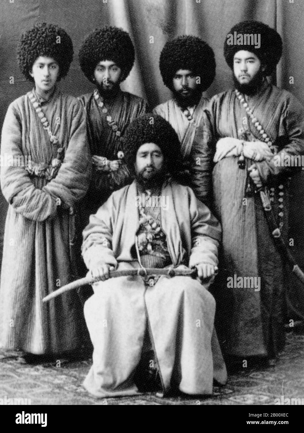 Uzbekistan: A high-ranking official of the Khanate of Khiva with his retinue, photographed by I. Volzhinsky c. 1896.  The Khanate of Khiva was a Central Asian state that existed in the historical region of Khwarezm from 1511 to 1920, except for a period of Persian occupation by Nadir Shah in 1740–46. Centered in the irrigated plains of the lower Amu Darya, south of the Aral Sea, with the capital in Khiva City, the country was ruled by the Kungrads, a branch of the Astrakhans, themselves a Genghisid dynasty. In 1873, the Khanate became a Russian protectorate Stock Photo