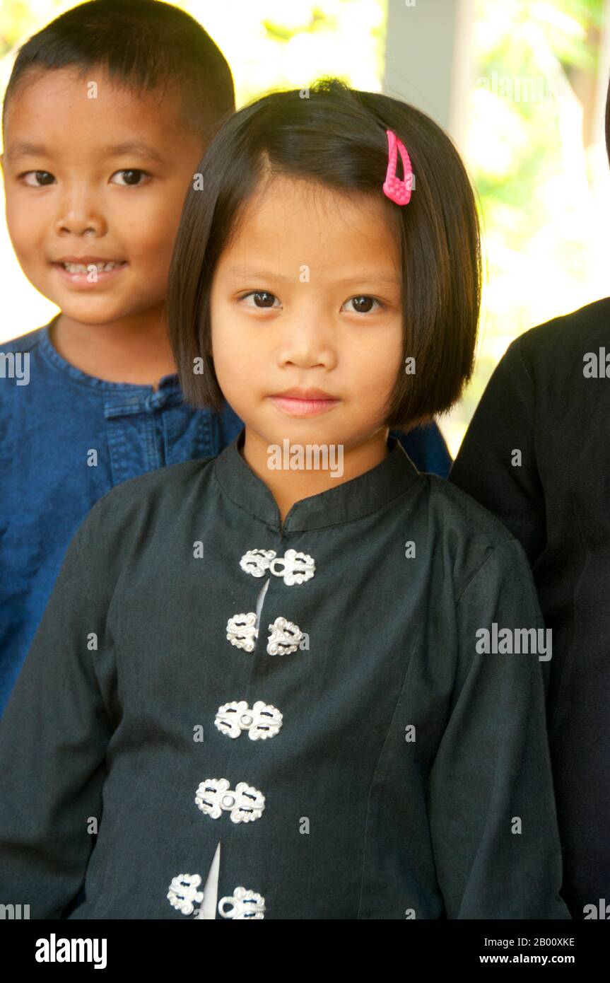 Thailand: Schoolchildren at the local school still wear Tai Dam traditional clothing to school, Ban Na Pa Nat Tai Dam Cultural Village, Loei Province.  The Tai Dam or Black Tai are an ethnic group found in parts of Laos, Vietnam, China, and Thailand.  Tai Dam speakers in China are classified as part of the Dai nationality along with almost all the other Tai peoples. But in Vietnam they are given their own nationality (with the White Tai) where they are classified as the Thái nationality (meaning Tai people).  The Tai Dam originate from the vicinity of Dien Bien Phu in Vietnam. Stock Photo