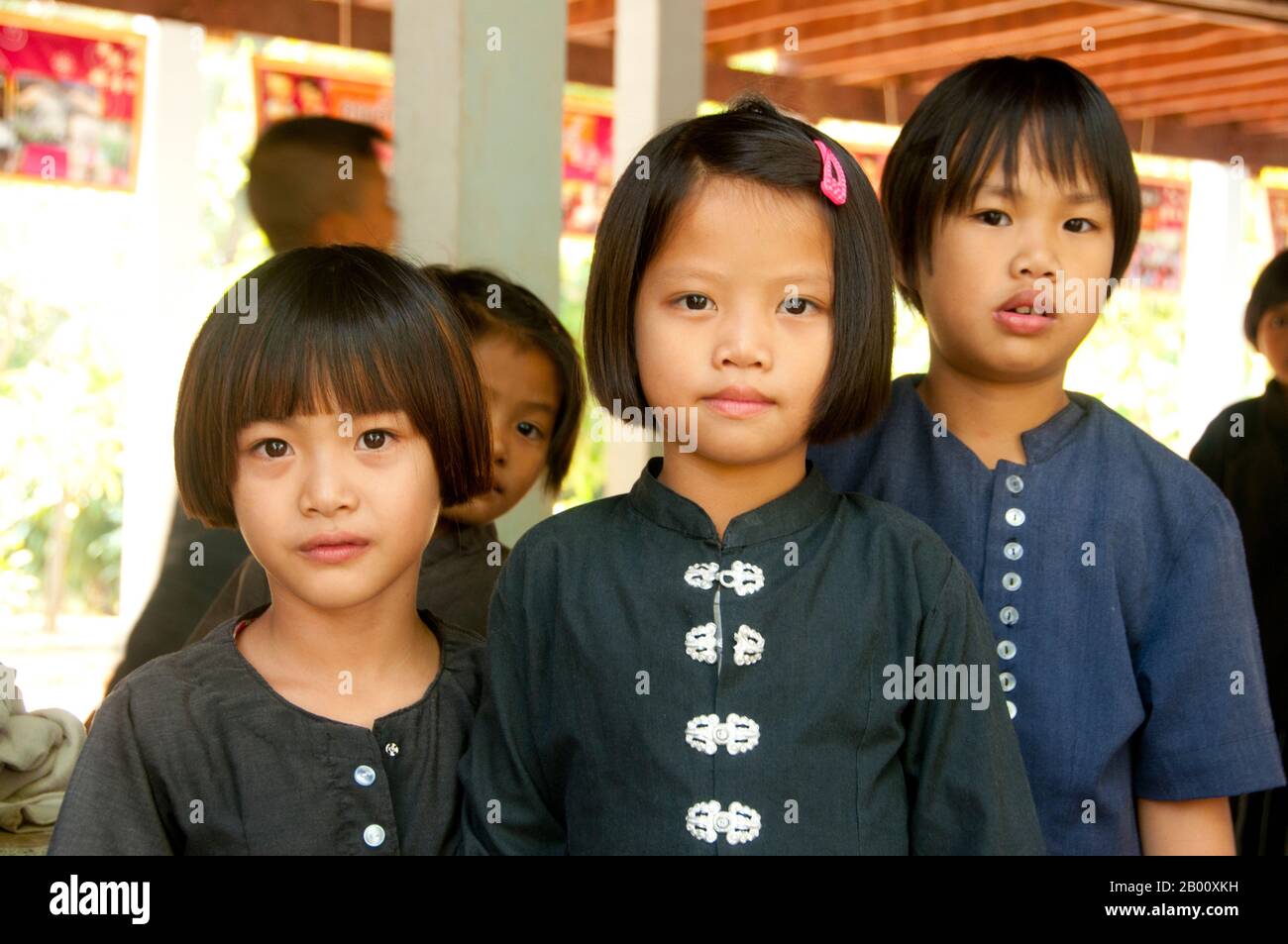 Thailand: Schoolchildren at the local school still wear Tai Dam traditional clothing to school, Ban Na Pa Nat Tai Dam Cultural Village, Loei Province.  The Tai Dam or Black Tai are an ethnic group found in parts of Laos, Vietnam, China, and Thailand.  Tai Dam speakers in China are classified as part of the Dai nationality along with almost all the other Tai peoples. But in Vietnam they are given their own nationality (with the White Tai) where they are classified as the Thái nationality (meaning Tai people).  The Tai Dam originate from the vicinity of Dien Bien Phu in Vietnam. Stock Photo