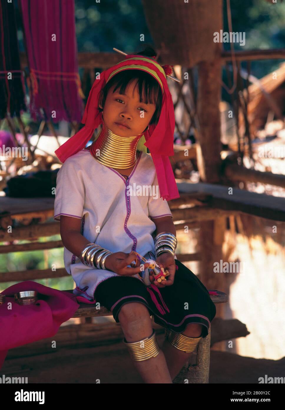 Thailand: Young Padaung (Long Neck Karen) girl, village near Mae Hong Son.  The Padaung or Kayan Lahwi or Long Necked Karen are a subgroup of the Kayan, a mix of Lawi tribe , Kayan tribe and several other tribes. Kayan are a subgroup Red Karen (Karenni) people, a Tibeto-Burman ethnic minority of Burma (Myanmar). Stock Photo