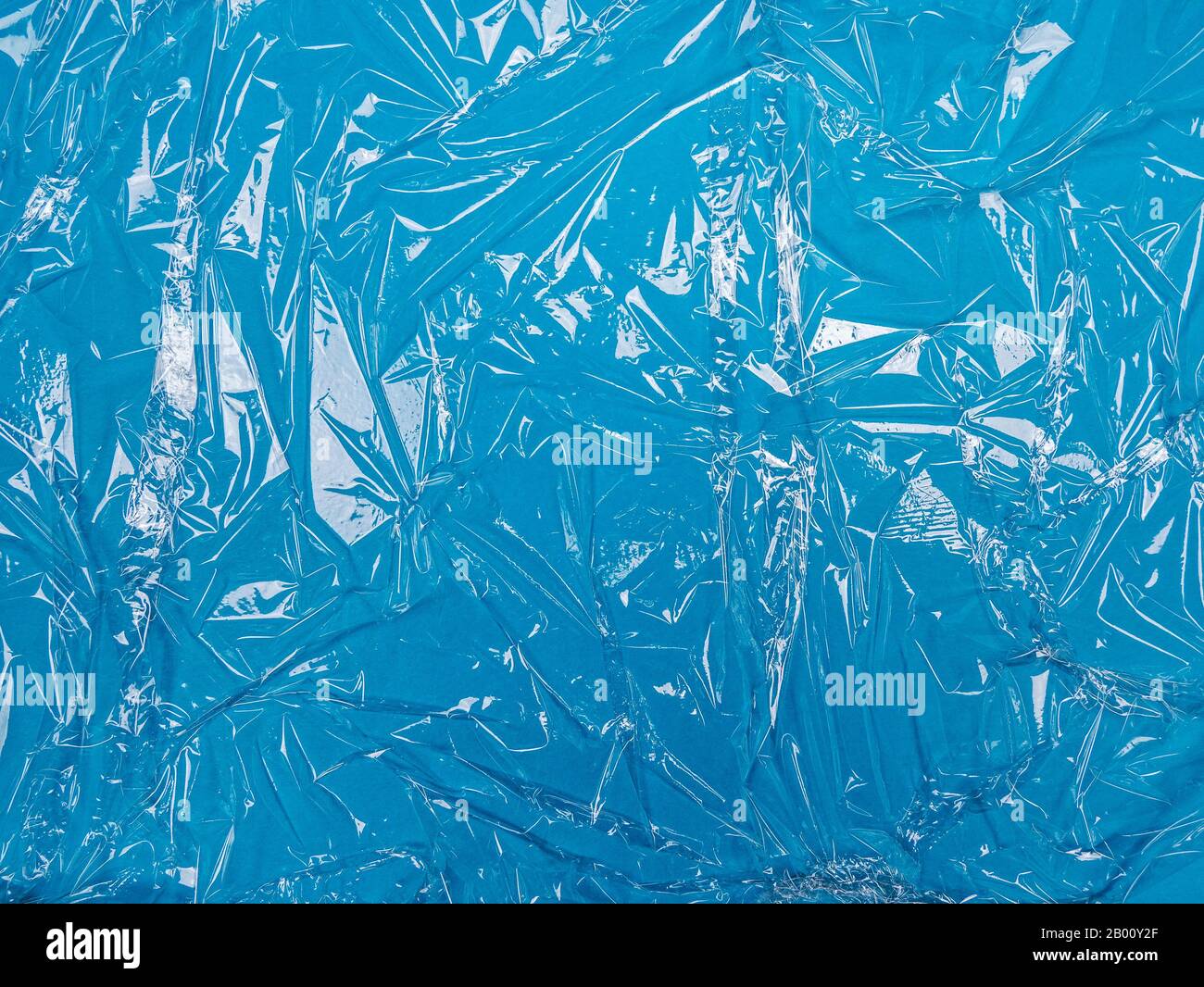 Transparent plastic foil on blue background Stock Photo