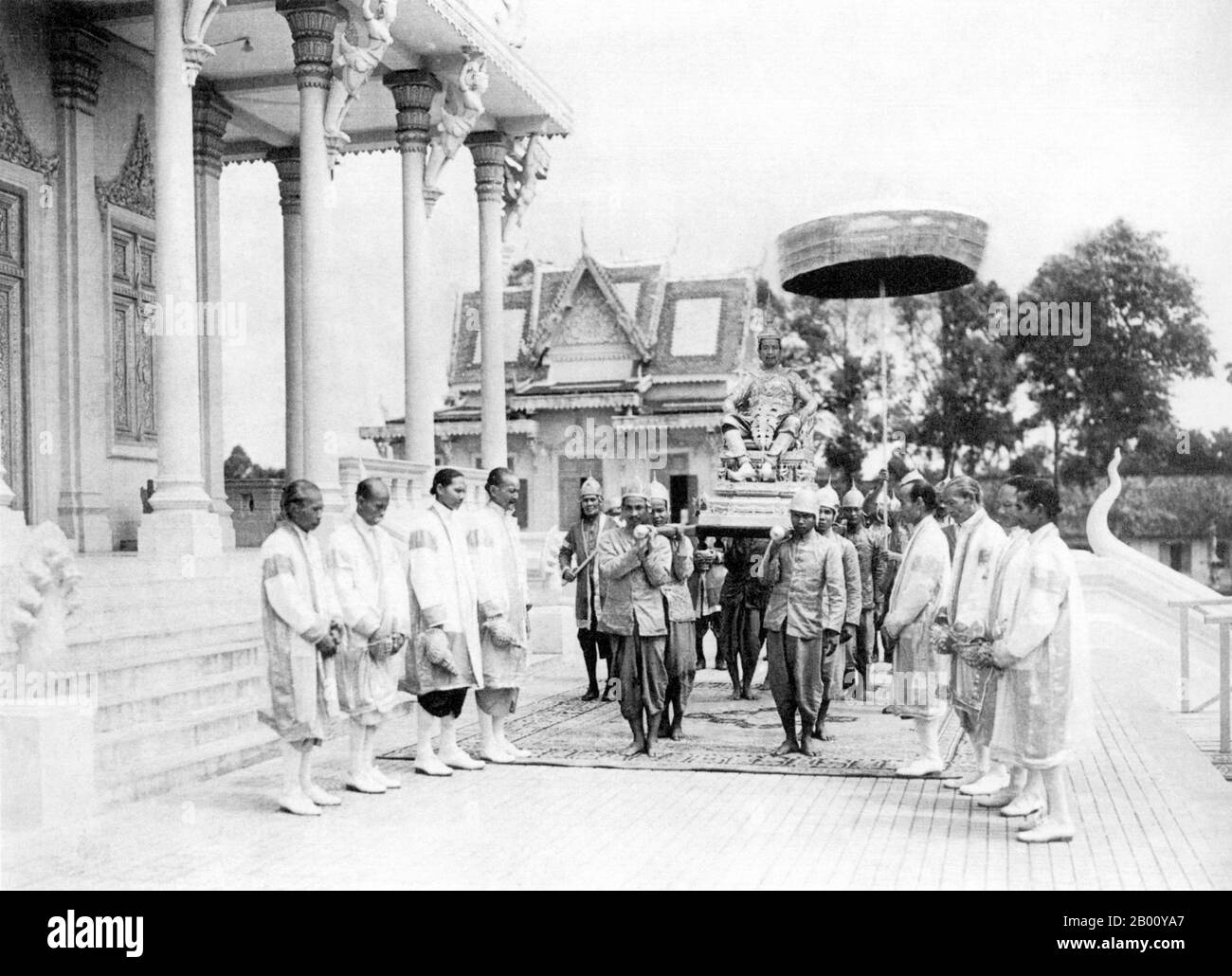 Cambodia: The crowning ceremony of HM Sisowath Monivong at the Royal Palace in Phnom Penh on 24 July, 1928. He is carried on a sedan while Brahmin attendants line up holding conches.  Preah Bat Sisowath Monivong (1875–1941) was the king of Cambodia from 1927 til 1941. The second son of King Sisowath, he was born during the reign of King Norodom who ruled from Oudong as a puppet king for the French colonial protectorate. In 1884, after the French conquered Laos and occupied Vietnam, Cambodia became a direct colonial possession. The royal family moved from Oudong to the new capital of Phnom Penh Stock Photo