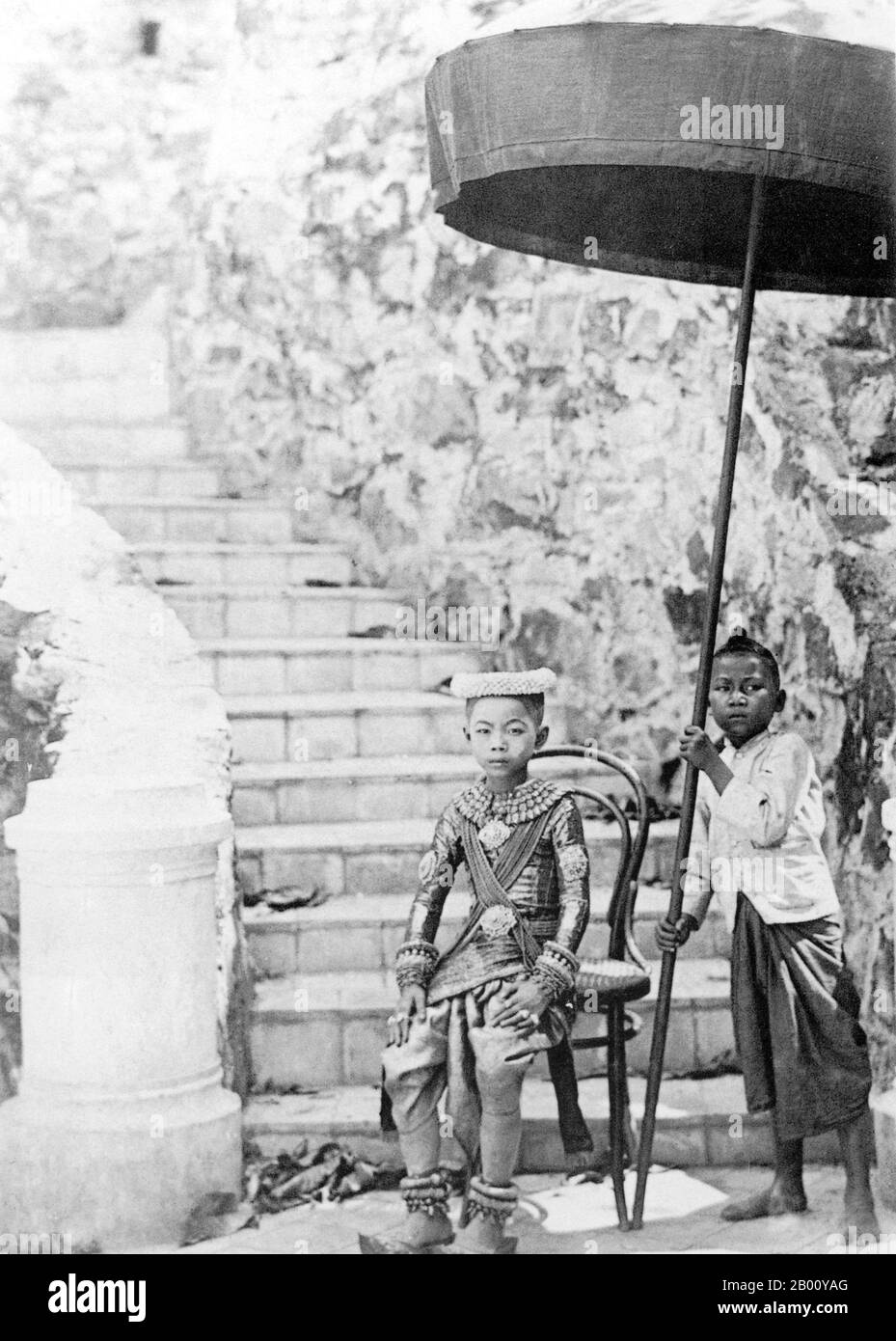 Cambodia: An unidentified young Khmer prince and attendant in Phnom Penh in 1921.  The little prince would most likely have been a relation of King Preah Bat Sisowath who ruled Cambodia from 1904, when King Norodom died, until his death in 1927 when he was succeeded by his son and crown prince, Prince Sisowath Monivong. Stock Photo