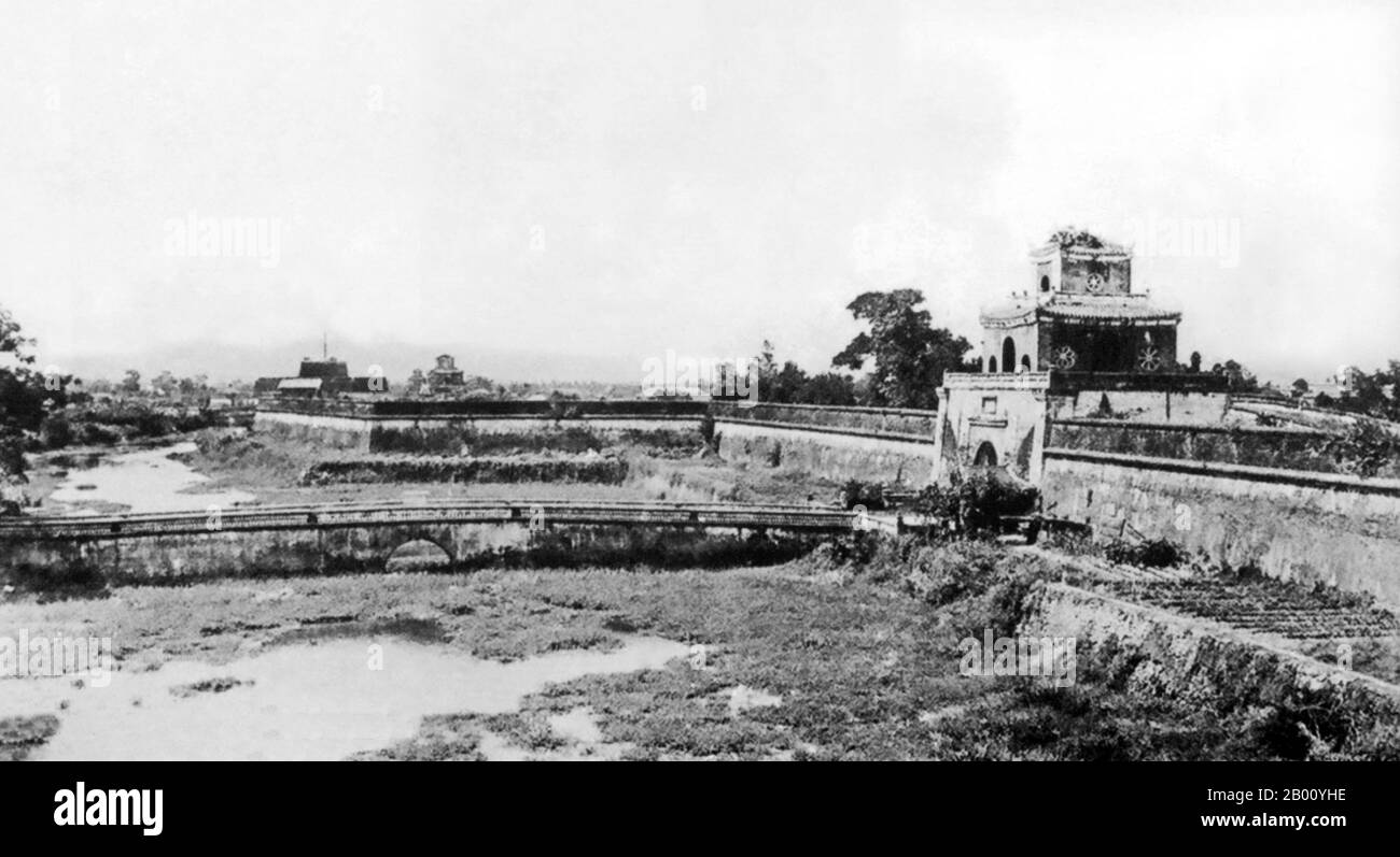 Vietnam: The Imperial Citadel at Hue. Photo by Pierre Dieulefils (1862-1937), late 19th century.  The Imperial City of Hue was surrounded by a wall 2 kilometers by 2 kilometers, and the walls were surrounded by a moat. The water from the moat was taken from the Huong River (Perfume River) that flows through Hue. This structure is called the citadel. In June 1802, Nguyen Phuc Anh took control of Vietnam and proclaimed himself Emperor Gia Long. His rule was recognized by China in 1804, the same year construction began on the new palace and citadel. Stock Photo