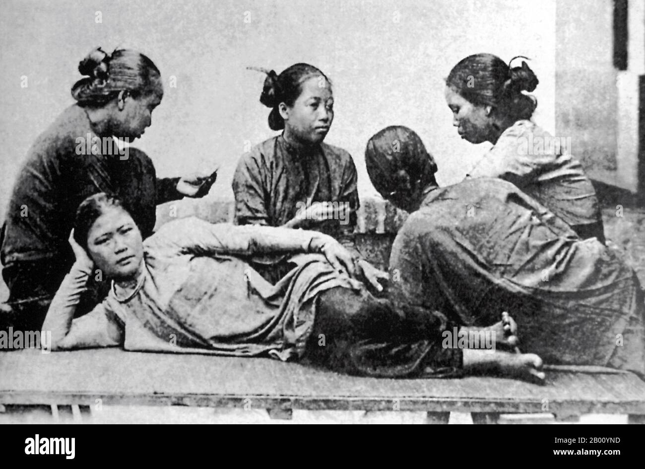 Vietnam: Women playing cards, Saigon, 1907.  Vietnam's independence was gradually eroded by France in a series of military conquests from 1859 until 1885 when the entire country became part of French Indochina. Significant political and cultural changes were placed on the Vietnamese people, including the propagation of Roman Catholicism. When Emperor Thanh Thai, who was opposed to French colonial rule, was exiled in 1907, the French decided to pass the throne to his son who was only seven years old, because they thought someone so young would be easily influenced and controlled. Stock Photo