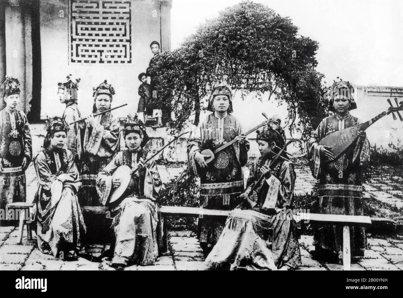 Vietnam: A royal orchestra of women at Hue (early 20th century).  Between 1802 and 1945, Hue was the imperial capital of the Nguyen Dynasty, a feudal kingdom which dominated much of southern Vietnam from the 17th to the 19th century. In 1775 when Trinh Sam captured it, it was known as Phu Xuan. In 1802, Nguyen Phuc Anh (later Emperor Gia Long) succeeded in establishing his control over the whole of Vietnam, thereby making Hue the national capital until 1945, when Emperor Bao Dai abdicated and a communist government was established in Hanoi. Stock Photo