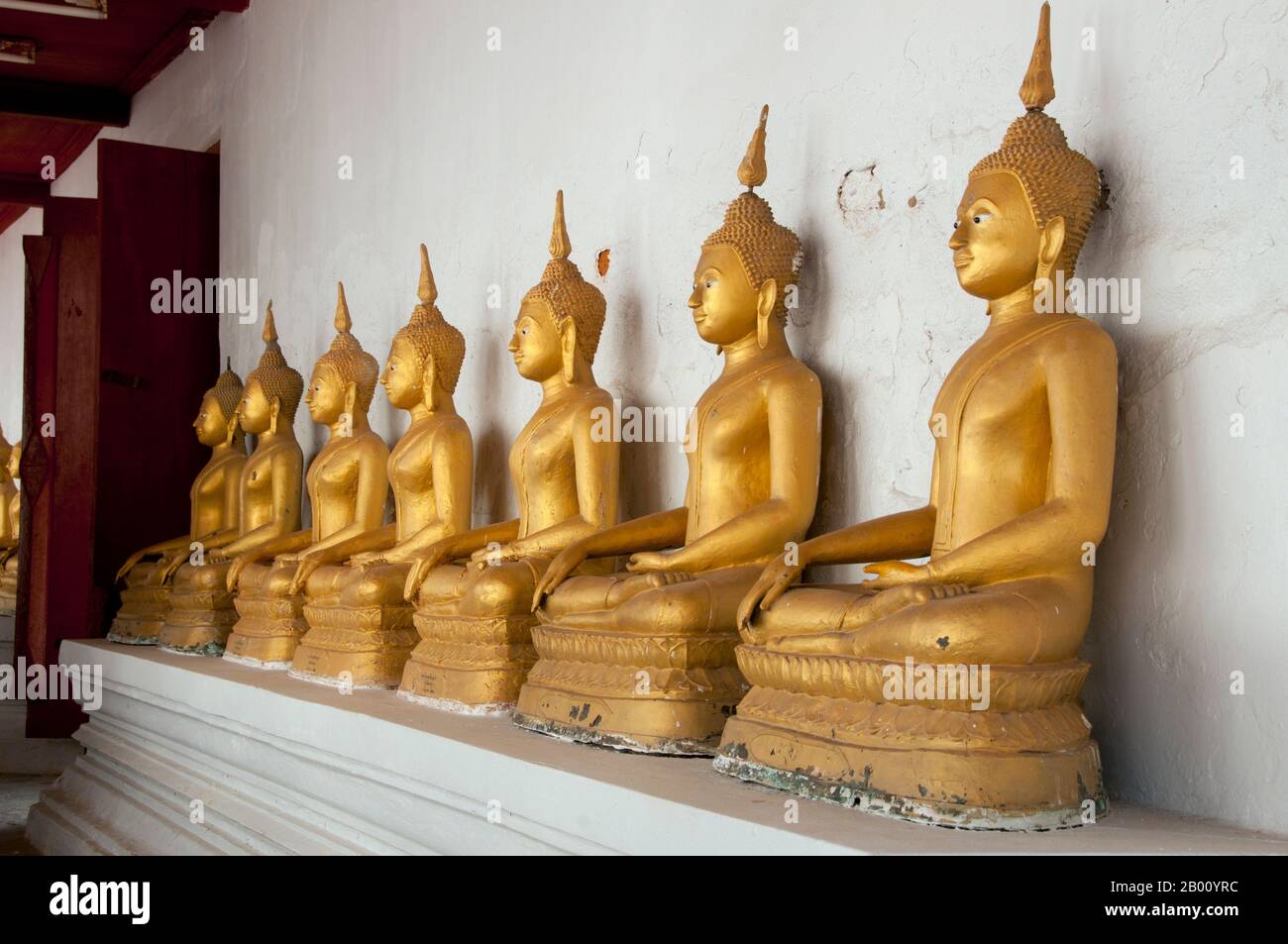 Thailand: A row of Buddhas at Wat Yai Suwannaram, Phetchaburi.  Wat Yai Suwannaram dates from the 17th century Ayutthaya period. Stock Photo