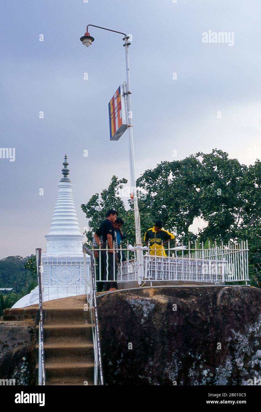 Sri Lanka: Visitors admire the view from Isurumuniya Vihara, Anuradhapura.  Isurumuniya Vihara is a rock temple built during the reign of King Devanampiya Tissa (r. 307 - 267 BCE).  Anuradhapura is one of Sri Lanka's ancient capitals and famous for its well-preserved ruins. From the 4th century BCE until the beginning of the 11th century CE it was the capital. During this period it remained one of the most stable and durable centers of political power and urban life in South Asia. The ancient city, considered sacred to the Buddhist world, is today surrounded by monasteries. Stock Photo