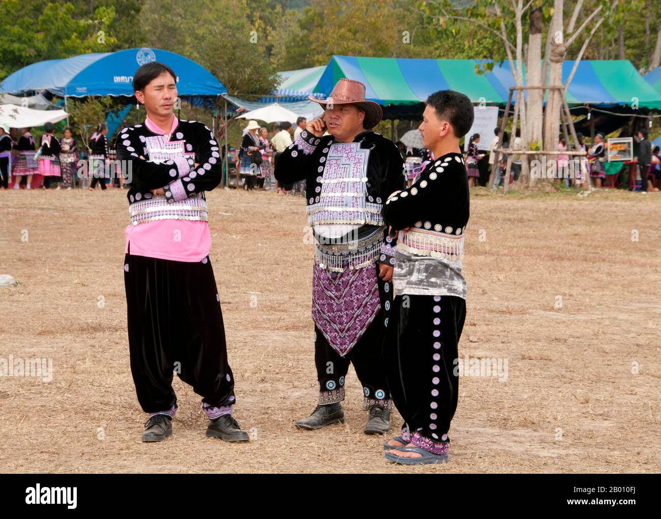 Thailand: Elder on his mobile, Hmong New Year celebrations, Chiang Mai, Northern Thailand.  Hmong New Year generally takes place in either November or December (traditionally at the end of the harvest season).  The Hmong are an Asian ethnic group from the mountainous regions of China, Vietnam, Laos, and Thailand. Hmong are also one of the sub-groups of the Miao ethnicity in southern China. Hmong groups began a gradual southward migration in the 18th century due to political unrest and to find more arable land. Stock Photo