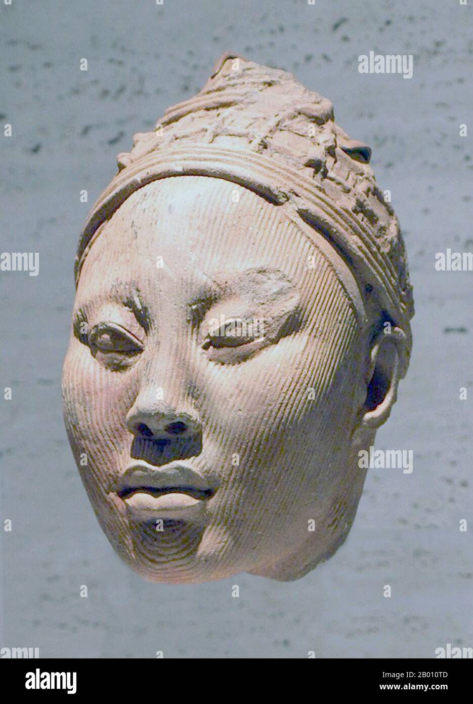 Nigeria: Terracotta head of a crowned Yoruba queen from the Kingdom of Ife.  Between 700 and 900 CE, the Ife Kingdom developed as a major artistic center. The city was a settlement of substantial size between the 9th and 12th centuries, with houses featuring potsherd pavements. Ife is known worldwide for its ancient and naturalistic bronze, stone and terracotta sculptures, which reached their peak of artistic expression between 1200 and 1400 A.D. After this period, production declined as political and economic power shifted to the nearby kingdom of Benin which, like the Yoruba kingdom of Oyo, Stock Photo