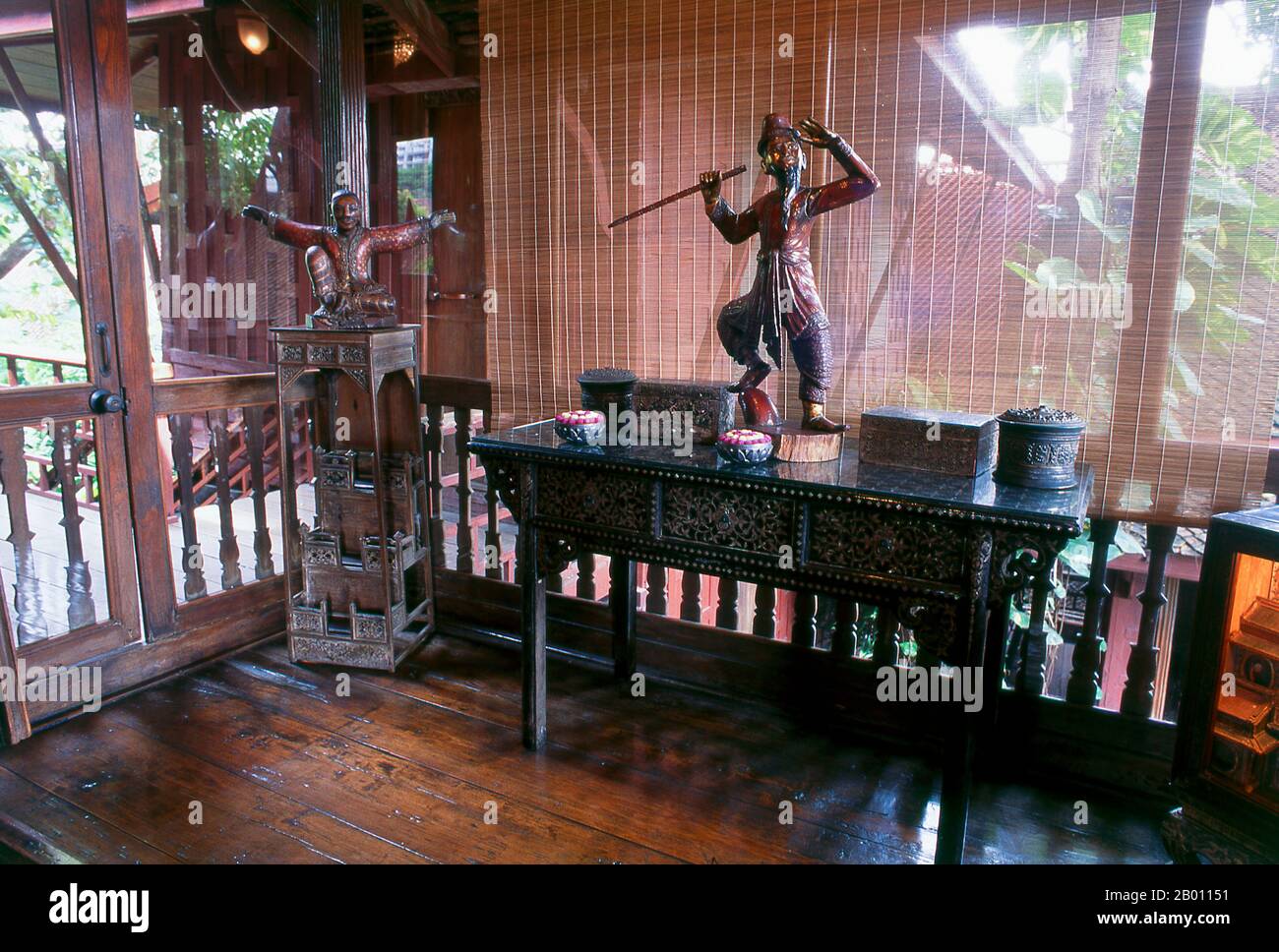 Thailand: Balcony section of the master bedroom, with Burmese figures, Jim Thompson House, Bangkok.  The Jim Thompson House is a museum in Bangkok. It is a complex of various old Thai structures that the American businessman Jim Thompson collected from all parts of Thailand in the 1950s and 60s.  James (Jim) Harrison Wilson Thompson (born March 21, 1906 in Greenville, Delaware - unknown) was an American businessman who helped revitalize the Thai silk industry in the 1950s-1960s. A former U.S. military intelligence officer, Thompson mysteriously disappeared while hiking in Malaysia in 1967. Stock Photo