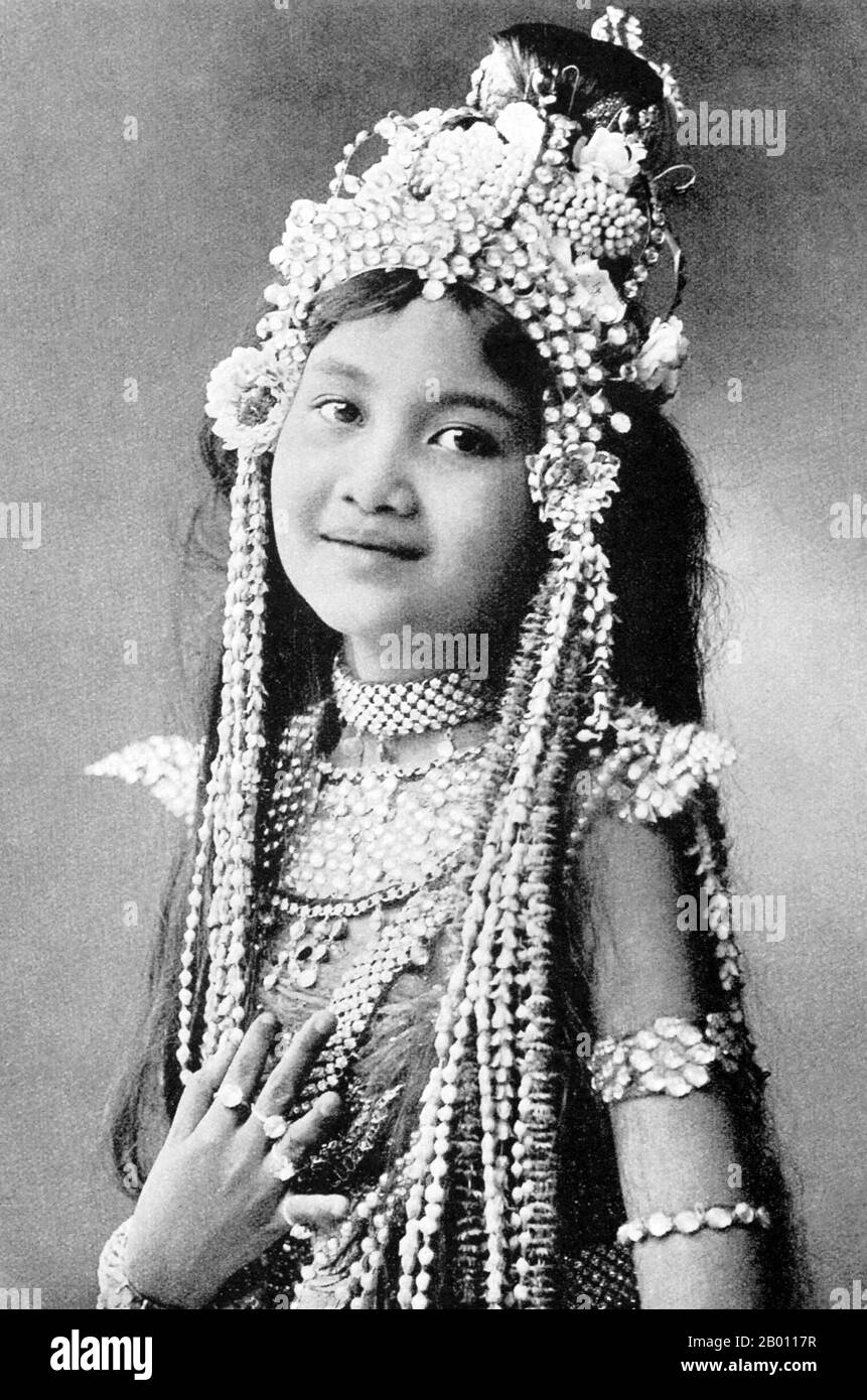Thailand: A young Siamese actress, c. 1900.  The Siamese were avid theatre-goers at the turn of the 20th century. Mime, dance, plays and shadow puppetry were all very popular. Many of the stage plays involved dancers, mostly female, who adorned themselves in jewellery and exhibited lithe movements portraying beauty and flexibility, especially in bending the fingers back. The most common plays were called ‘khon’, which essentially feature scenes from the ‘Ramakien’, the Thai version of the Hindu epic ‘The Ramayana’. Stock Photo