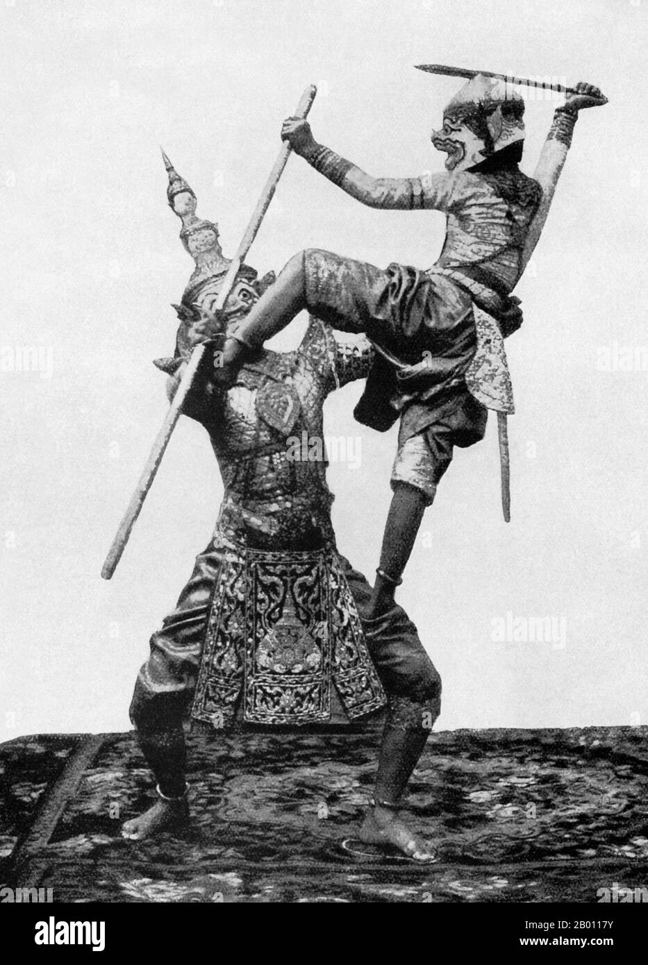 Thailand: Two Siamese theatre actors portray a fight scene between Thotsakan and Hanuman from the play ‘Ramakien’, c. 1900.  The Siamese were avid theatre-goers at the turn of the 20th century. Mime, dance, plays and shadow puppetry were all very popular. Many of the stage plays involved dancers, mostly female, who adorned themselves in jewellery and exhibited lithe movements portraying beauty and flexibility, especially in bending the fingers back. The most common plays were called ‘khon’, which essentially feature scenes from the ‘Ramakien’, the Thai version of the Hindu epic ‘The Ramayana’. Stock Photo
