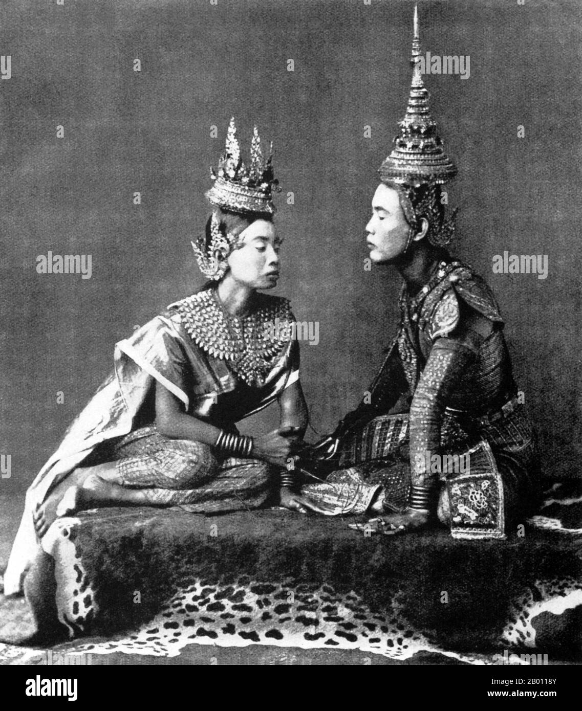 Thailand: Two actors enact the farewell scene from the Siamese play ‘I Nao’, c. 1900.   The Siamese were avid theatre-goers at the turn of the 20th century. Mime, dance, plays and shadow puppetry were all very popular. Many of the stage plays involved dancers, mostly female, who adorned themselves in jewellery and exhibited lithe movements portraying beauty and flexibility, especially in bending the fingers back. The most common plays were called ‘khon’, which essentially feature scenes from the ‘Ramakien’, the Thai version of the Hindu epic ‘The Ramayana’. Stock Photo