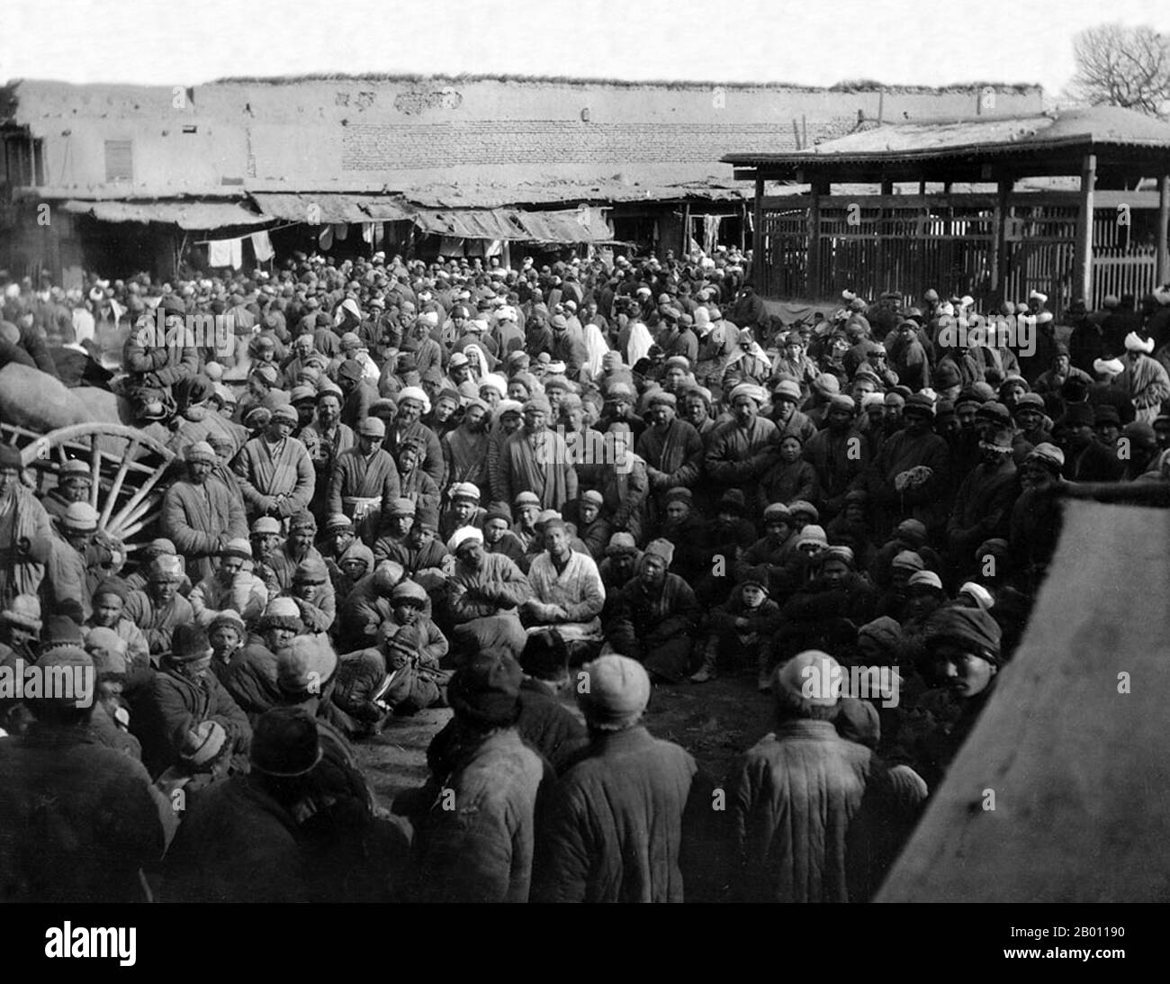 China: A crowd listening to a storyteller, Kashgar bazaar, Xinjiang. Photograph by Dutch botanist Frank Nicholas Meyer (1875-1918), 1911. The earliest mention of Kashgar occurs when a Chinese Han Dynasty (206 BCE – 220 CE) envoy traveled the Northern Silk Road to explore lands to the west. Another early mention of Kashgar is during the Former Han (also known as the Western Han Dynasty), when in 76 BCE the Chinese conquered the Xiongnu, Yutian (Khotan), Sulei (Kashgar), and a group of states in the Tarim basin almost up to the foot of the Tian Shan mountains. Stock Photo