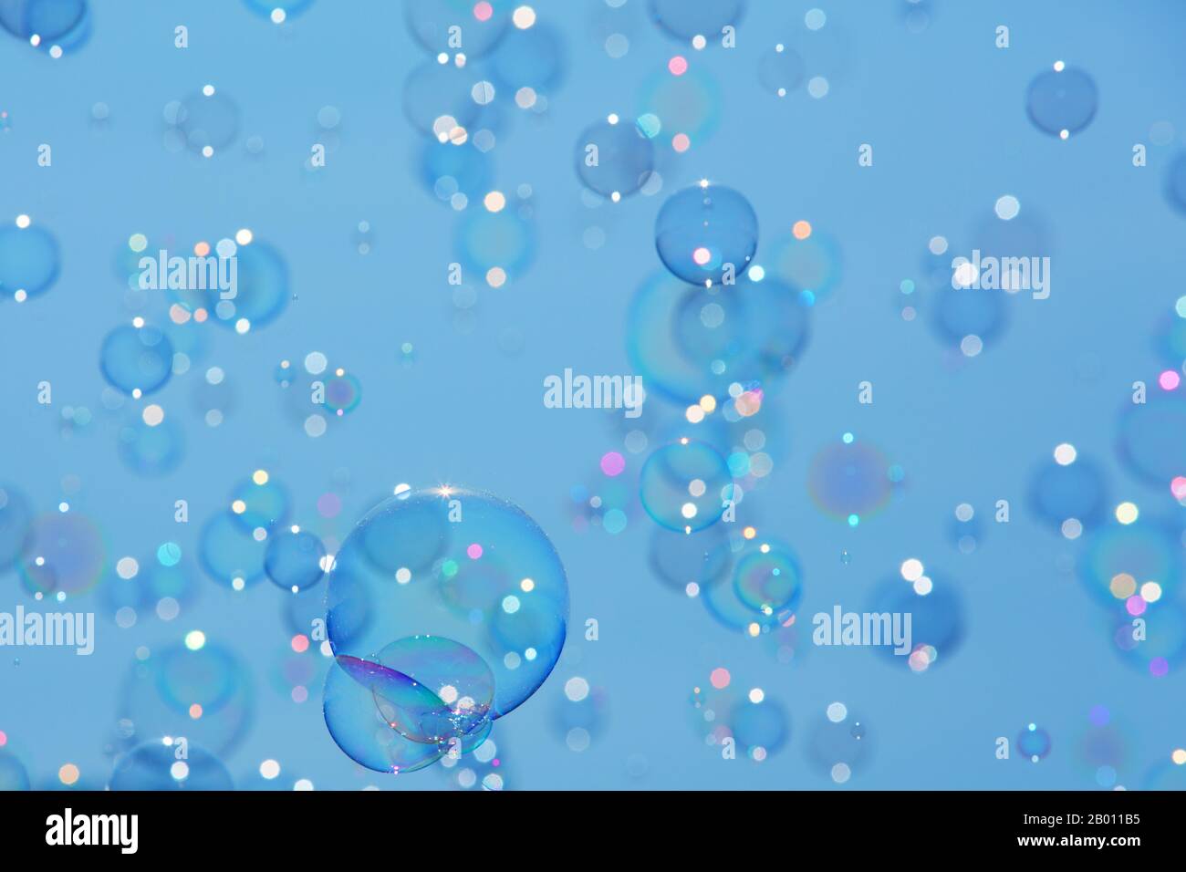 Delicate soap bubbles floating in a blue sky Stock Photo - Alamy