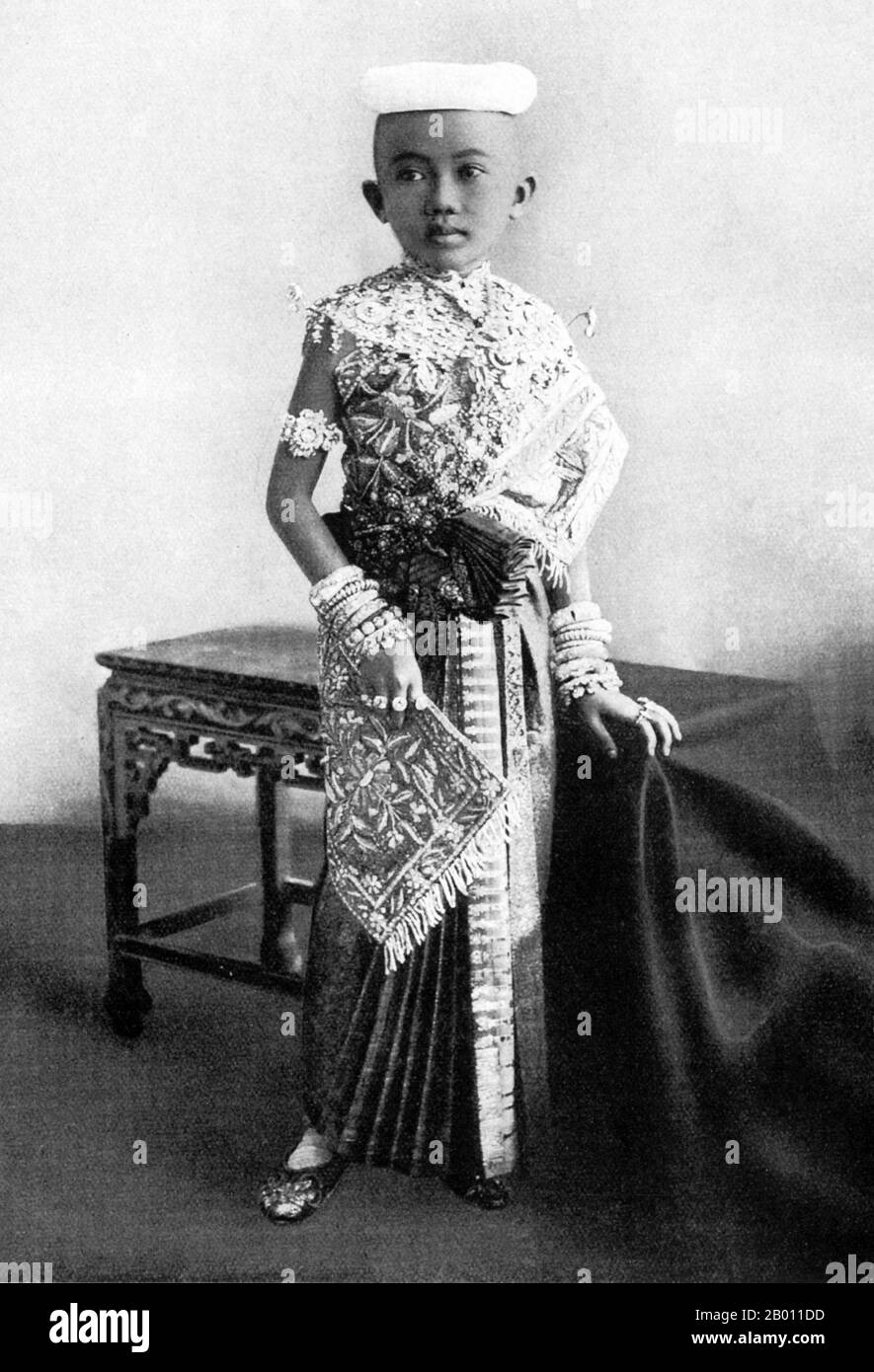 Thailand: A royal prince dressed and adorned for his tonsure ceremony, Siam, late 19th century.  In 19th-century Siam, almost every young male in the royal family entered the ‘sangha’ or Buddhist monkhood as a rite of passage. The tonsure ceremony was an initial act of this rite as all novices must have their heads shaved to enter the monastic order. The tradition survives to this day, not just among Thai royalty, but at all levels of society. Stock Photo