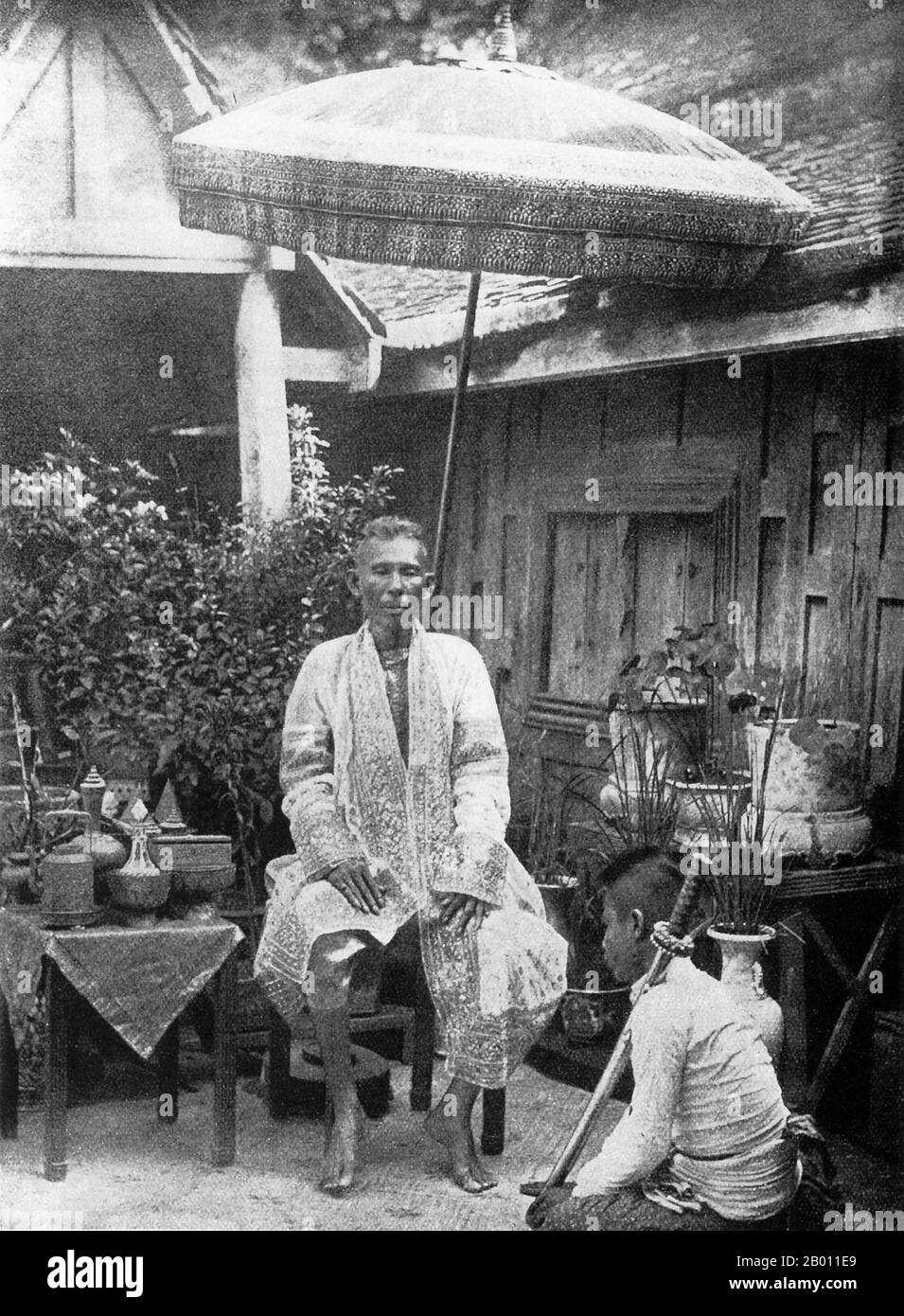 Thailand: Dressed in a gold embroidered robe, a prince is attended by a servant during the reign of King Mongkut (1851-1868).  Rama IV, known in foreign countries as King Mongkut (1804-1868), was the fourth monarch of Siam under the House of Chakri, and ruled from 1851 to his death in 1868. He was one of the most revered monarchs of the country. Outside of Thailand, he is best-known as the King in the 1951 play and 1956 film The King and I. During his reign, the pressure of Western expansionism was felt for the first time in Siam. Stock Photo