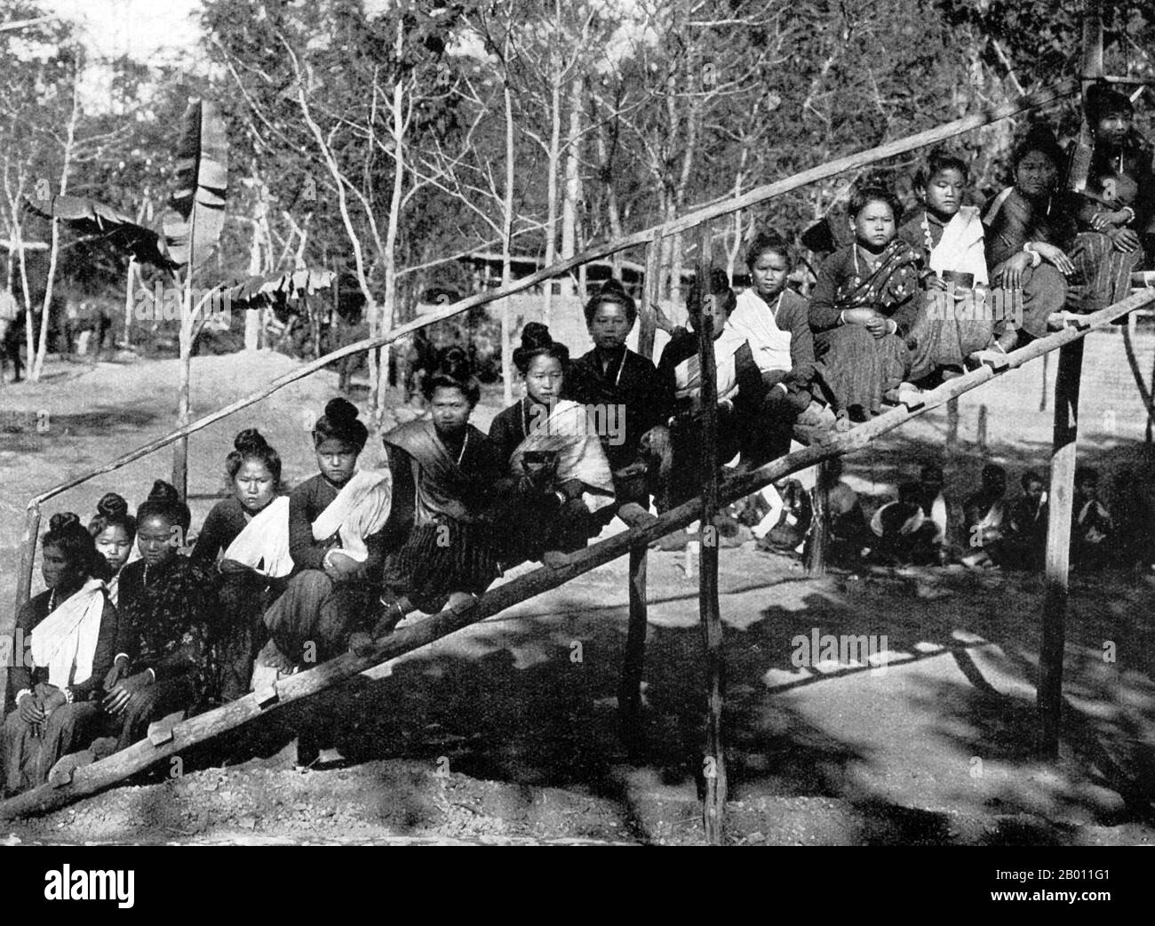 Thailand: Young northern Thai women pose for a photograph on a wooden stairway, c. 1900.  Known to the central Siamese as the Lao States at the turn of the 20th century, the northern region of what is now Thailand was an independent region known as the Lanna kingdom. The main city, Chiang Mai, was built in 1296 by King Mengrai. The city was abandoned in 1776—91 due to Burmese invasions, but became an acknowledged part of Siam around the same time. The north was linked to Bangkok only by river, a journey which could take some six months until, in 1922, a railway was completed. Stock Photo