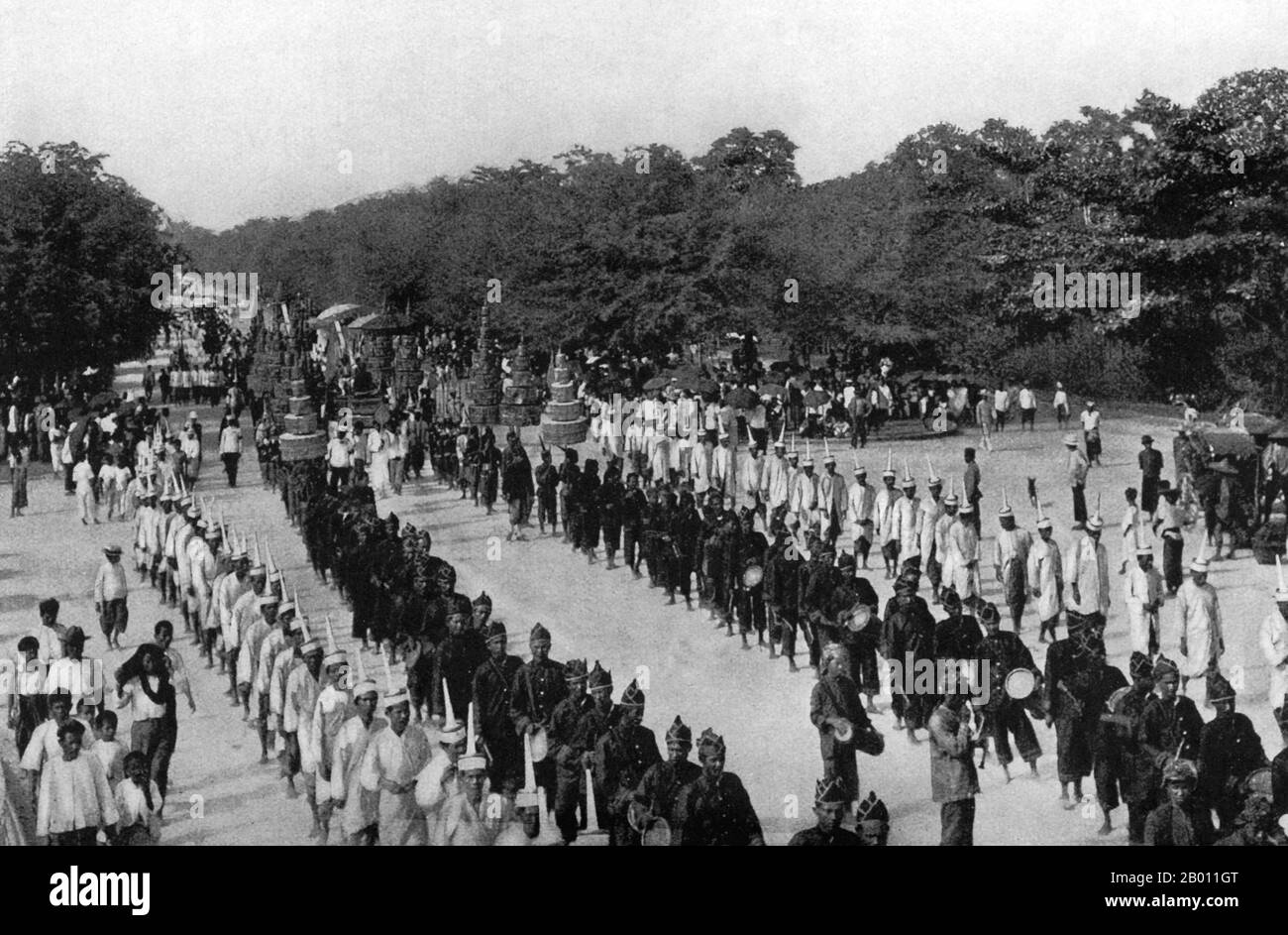 Thailand: A funeral procession accompanies the urn carrying the ashes of Prince Uruphong in Bangkok in 1909.   Elaborate pavilions and Buddhist temples are traditionally constructed especially for royal funerals in Siam. The body of the deceased was embalmed and preserved while the cremation site was built. Funereal rites and a period of mourning could take months or even a year before the funeral took place. The embalmed body was then placed in a kneeling position in a gold urn on a high bier inside an ornate edifice to be cremated. Stock Photo