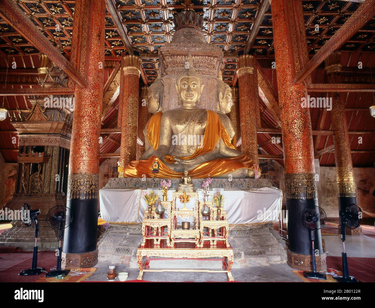 Thailand: Four identical Sukhothai-style Buddha images at the centre of Wat Phumin, Nan, North Thailand.  Wat Phumin was constructed in 1596 and is famous for its cruciform ubosoth and well preserved Tai Lue murals depicting everyday life in the 19th century.  Nan dates from the mid-14th century and for much of its history was an isolated kingdom. The present day city spreads out along the Nan River's right bank. Stock Photo