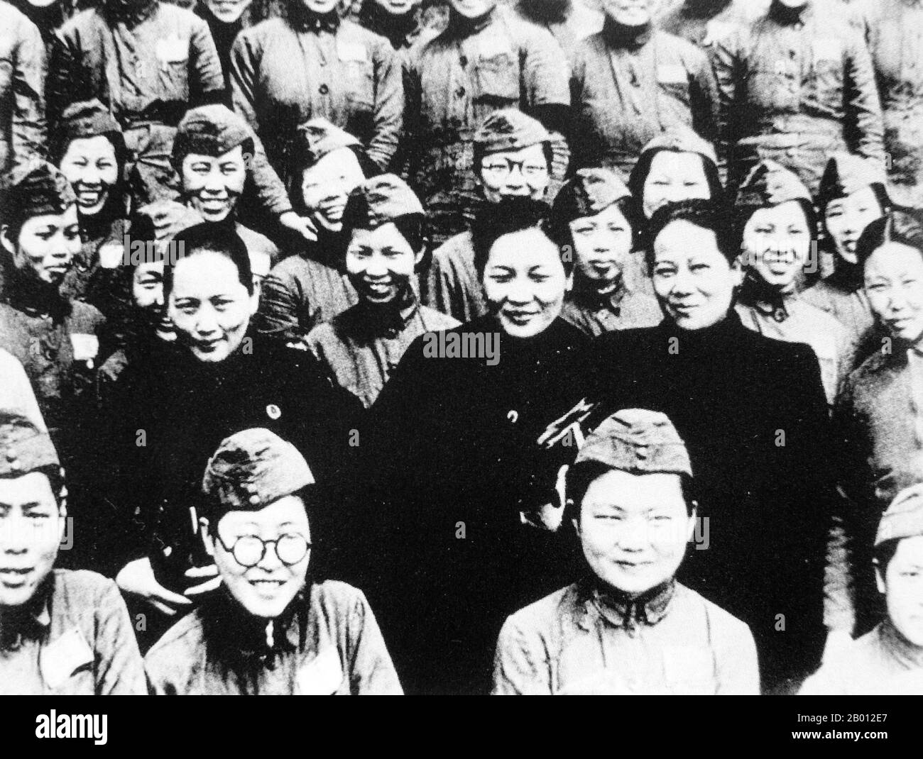 China: The Soong Sisters, Ailing, Meiling and Qingling Soong (in black) visiting Nationlist women soldiers, 1940s.  The Soong Sisters (Songjia Jiemei, or 'Song Household Sisters') were three Hakka Chinese women who were, along with their husbands, among China's most significant political figures of the 20th century. They each played a major role in influencing their husbands, which, along with their own positions of power, ultimately changed the course of Chinese history. Stock Photo
