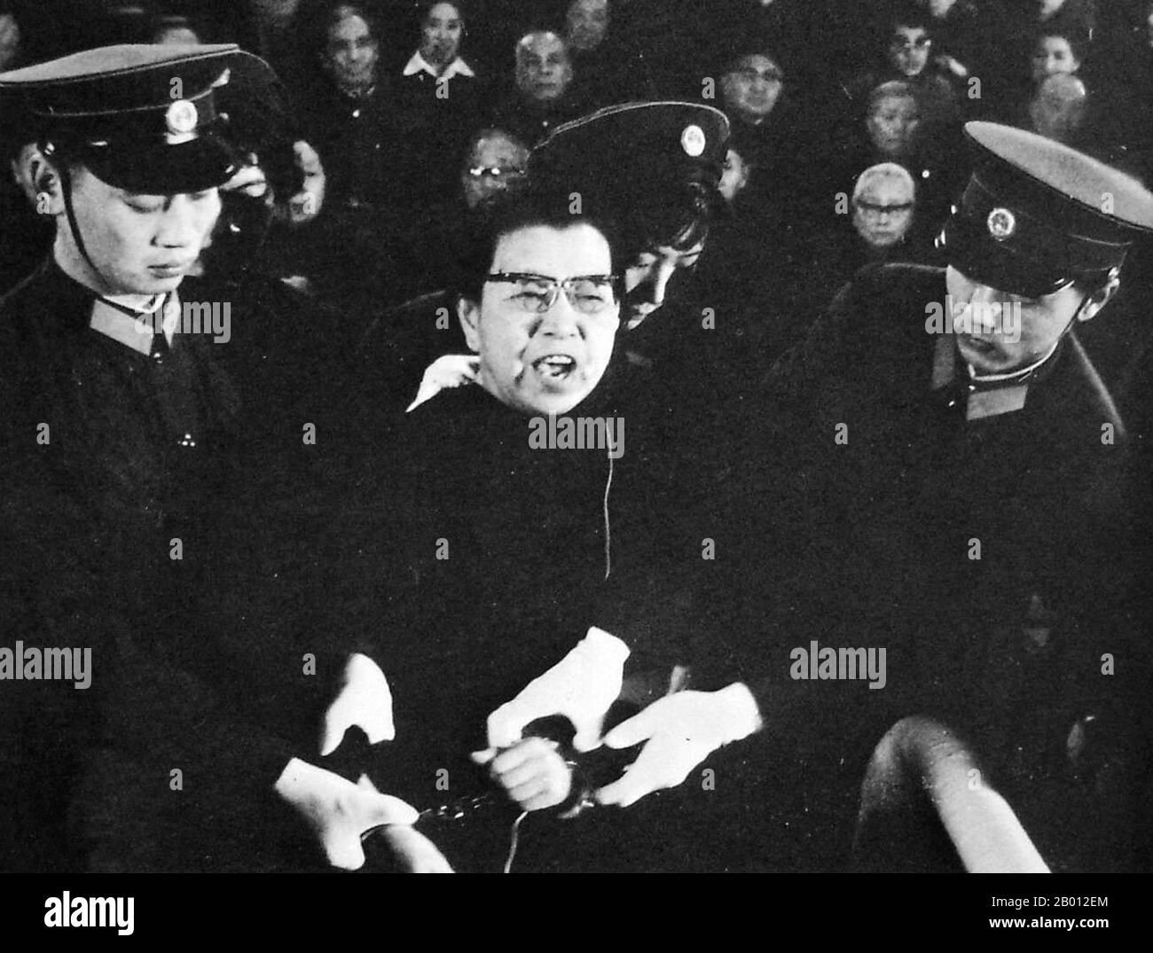 China: Jiang Qing (1914-1991), also known as Madame Mao, after her fall from power and arrest as a counter-revolutionary. She was handcuffed and defiant in court, c. 1980.  Jiang Qing (Chiang Ch'ing, March 1914  – May 14, 1991) was the pseudonym that was used by Chinese leader Mao Zedong's last wife and major Communist Party of China power figure.  She went by the stage name Lan Ping during her acting career, and was known by various other names during her life. She married Mao in Yan'an in November 1938, and is sometimes referred to as Madame Mao in Western literature, serving as first lady. Stock Photo