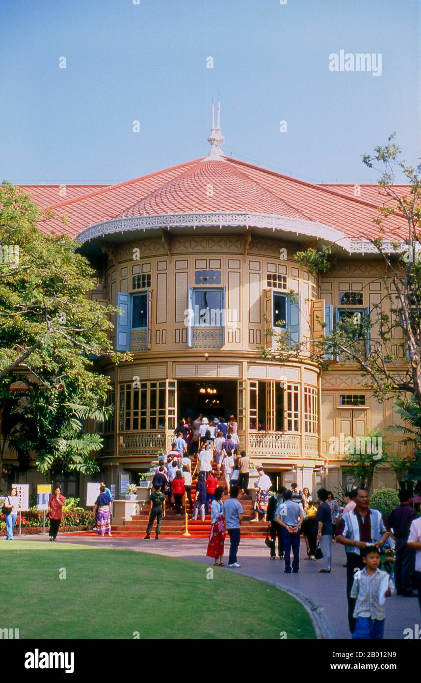 Thailand: Vimanmek Mansion, Dusit Park, Bangkok.  The Vimanmek Mansion is a former royal palace and is also known as the Vimanmek Teak Mansion or Vimanmek Palace.  Vimanmek Mansion was built in 1900 by King Rama V (King Chulalongkorn) by having the Munthatu Rattanaroj Residence in Chuthathuj Rachathan at Ko Sichang, Chonburi, dismantled and reassembled in Dusit Garden. It was completed on March 27, 1901 and used as a royal palace by King Rama V for five years.<  In 1982 Queen Sirikit asked permission of King Rama IX (Bhumibol Adulyadej) to renovate Vimanmek Palace for use as a museum. Stock Photo