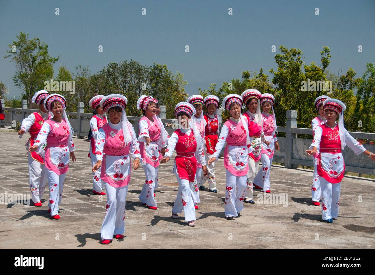 China: Bai women dancing at the Bai music and dance festival at San Ta Si (Three Pagodas), Dali, Yunnan.  The Bai or Baip are one of the 56 ethnic groups officially recognized by the People's Republic of China. Bai people live mostly in the provinces of Yunnan (Dali area), and in neighboring Guizhou (Bijie area) and Hunan (Sangzhi area) provinces.  Dali is the ancient capital of both the Bai kingdom Nanzhao, which flourished in the area during the 8th and 9th centuries, and the Kingdom of Dali, which reigned from 937-1253. Dali is situated in a once significantly Muslim part of South China. Stock Photo