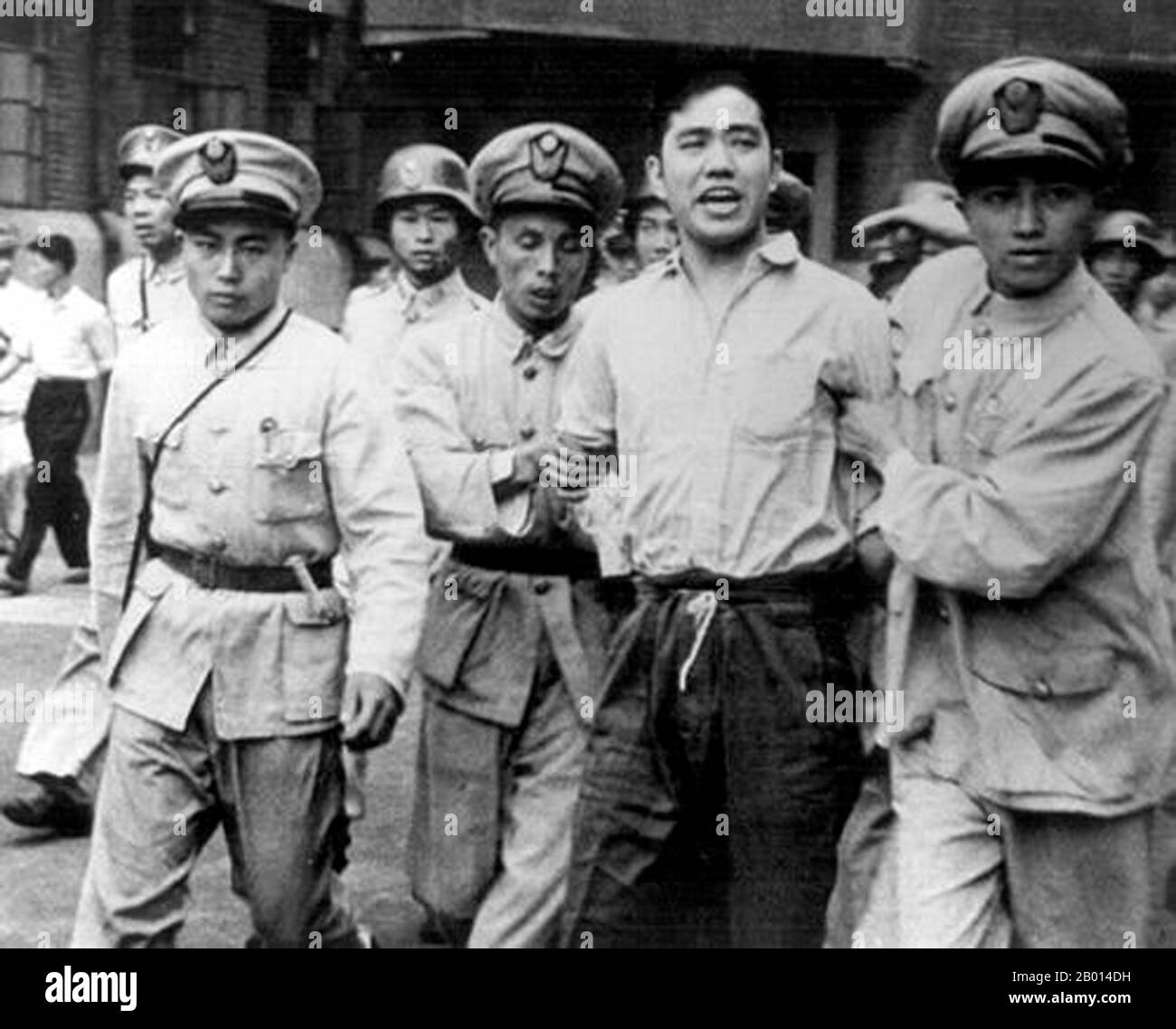 China: Wang Xiaohe (1924-1948) arrested and led away by Kuomintang security forces in Shanghai, 30 September, 1948. He was executed the same day. Wang Xiaohe worked at the Shanghai Electric Power Company and was a union organiser and underground member of the Chinese Communist Party. The Chinese Civil War was a conflict fought between forces loyal to the Kuomintang (KMT)-led government of the Republic of China, and forces loyal to the Communist Party of China (CPC). The war began in August 1927, with Chiang Kai-Shek's Northern Expedition, and ended when major active battles ceased in 1950. Stock Photo