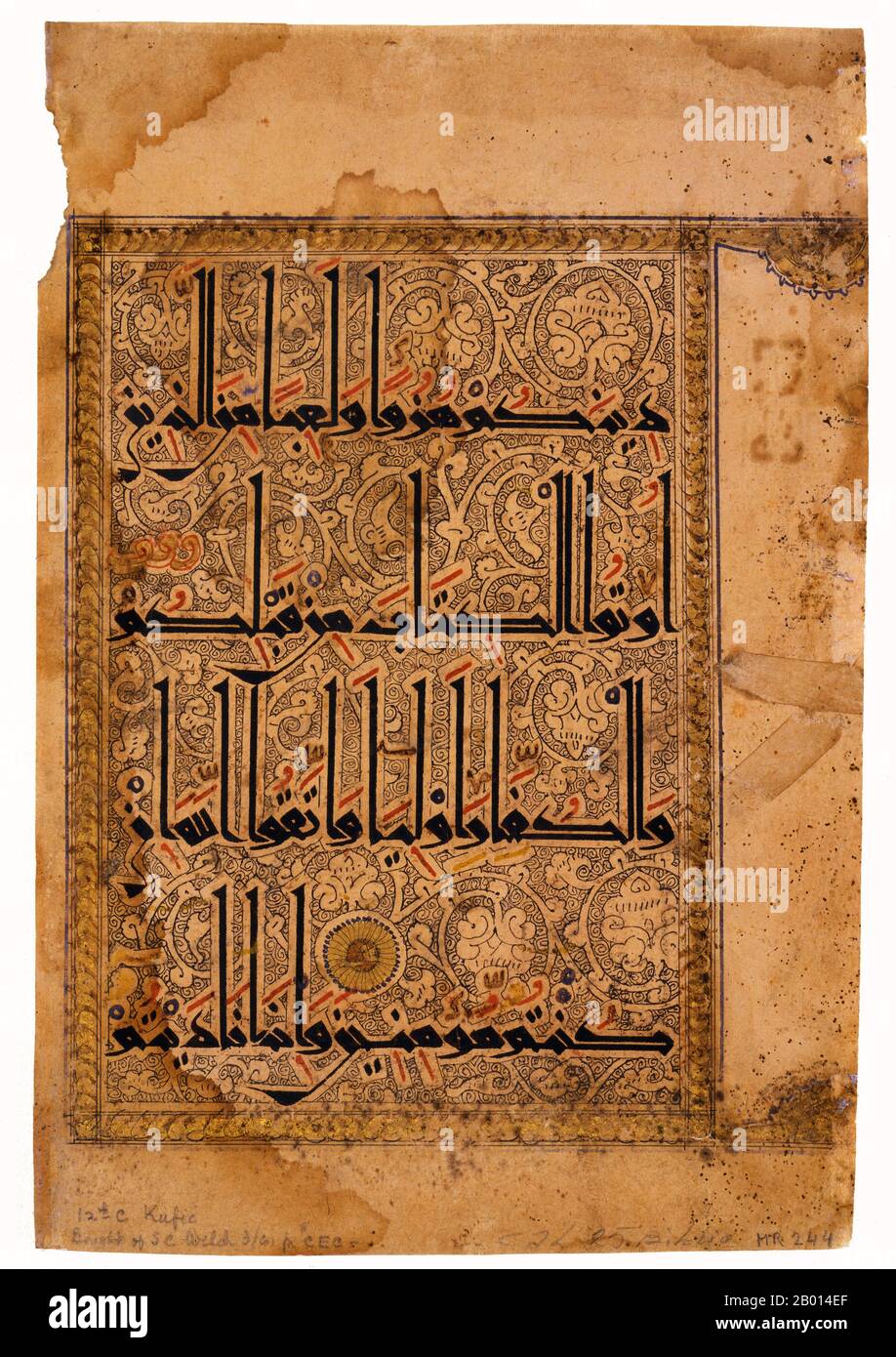 Iran: Illustrated page from an 11th century Qur'an written in Eastern Kufic script.  Eastern Kufic script is distinguished by tall upstrokes that often have left-facing serifs and curved downstrokes. The various diacritical marks that facilitate reading are carefully marked with red, blue, and black. Eastern Kufic was introduced in the 10th century at the same time as paper became the preferred material for Korans in the eastern Islamic world. Stock Photo