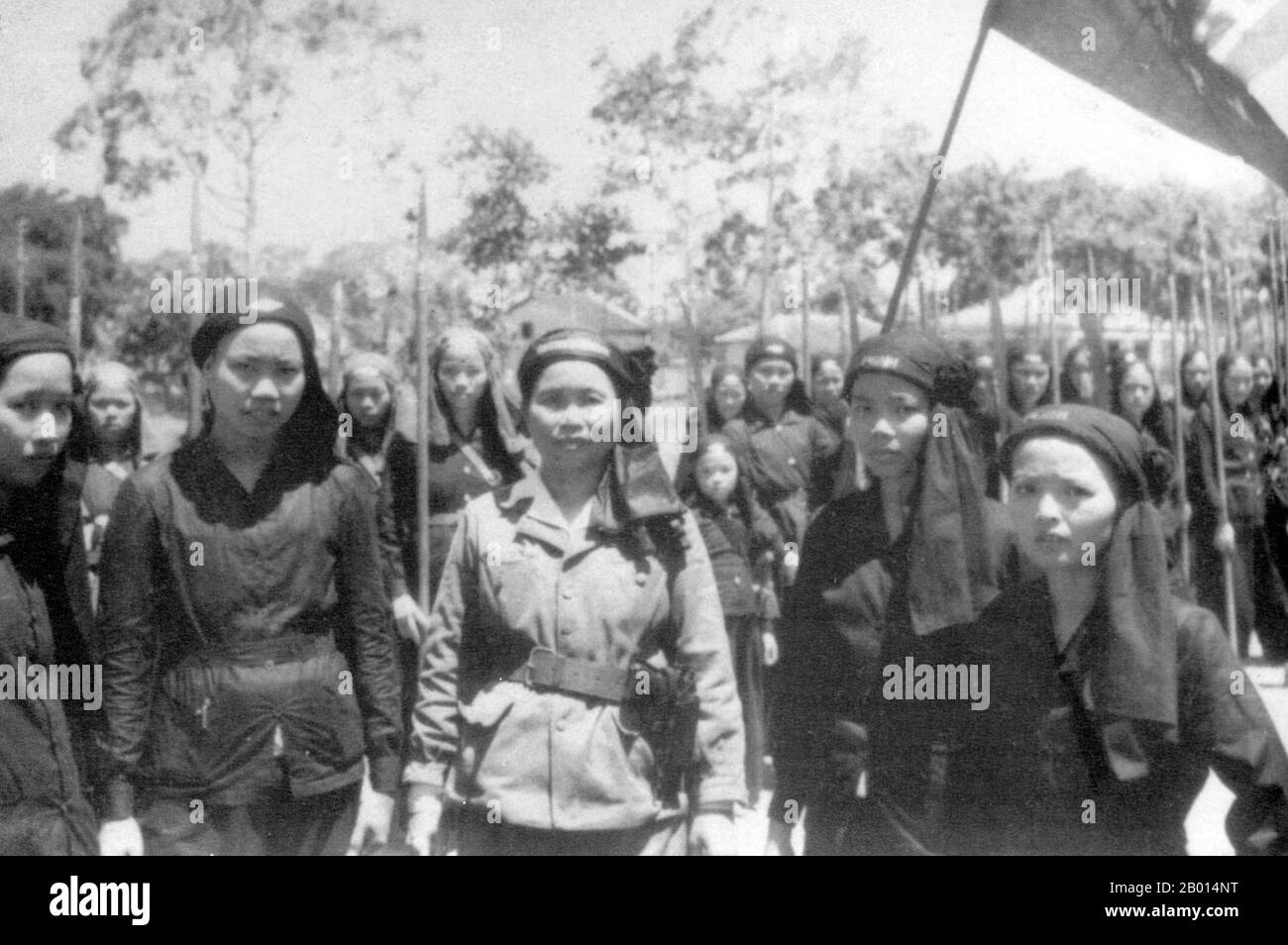 Vietnam: Hoa Hao female militia in the Mekong Delta, c. 1954.  Hoa Hao is a religious tradition, based on Buddhism, founded in 1939 by Huynh Phy Sy, a native of the Mekong River Delta region of southern Vietnam. When America began intervening in South Vietnam, the most powerful groups to concern the Americans were the Cao Dai, the Binh Xuyen and the Hoa Hao, which had formed a small private army under General Ba Cụt. O.S.S. Colonel Edward Lansdale used bribery with CIA funds to split the Hoa Hao and in 1956 General Duơng Van Minh crushed the Hoa Hao and General Ba Cụt was captured and beheaded Stock Photo