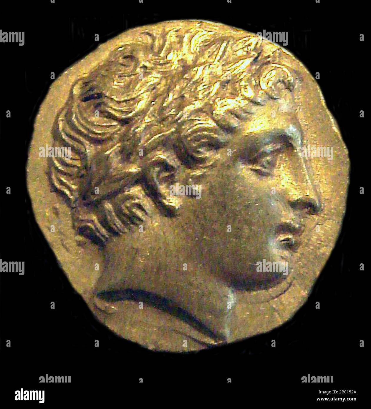 Greece: Head of Apollo on a gold stater coin struck by Philip II of Macedon (r.359-336 BCE). Photo by PHGCOM (CC BY-SA 4.0 License).  Apollo is one of the most important and diverse of the Olympian deities in Greek and Roman mythology. The ideal of the kouros (a beardless, athletic youth), Apollo has been variously recognized as a god of light and the sun; truth and prophecy; medicine, healing, and plague; music, poetry, and the arts; and more.  Apollo is the son of Zeus and Leto, and has a twin sister, the chaste huntress Artemis. Stock Photo