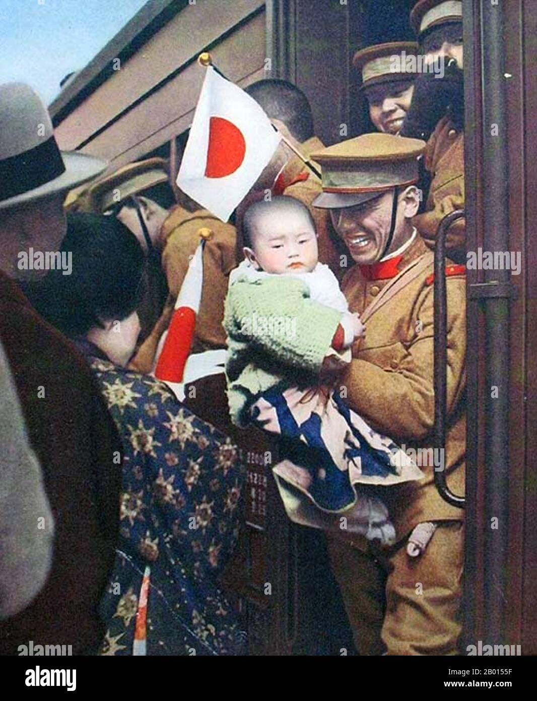 China: A Japanese soldier says goodbye to a young child before boarding a troop train in Manchuria, 1933.  The Second Sino-Japanese War is usually dated from 1937 to Japan's final defeat in 1945, but in fact Japan and China had been in a state of undeclared war from the time of the Mukden Incident in 1931 when Japan seized Manchuria and set up the puppet state of Manchukuo. The Japanese installed the former Qing Emperor Puyi as Head of State in 1932, and two years later he was declared Emperor of Manchukuo with the era name of Kangde ('Tranquility and Virtue'). Stock Photo