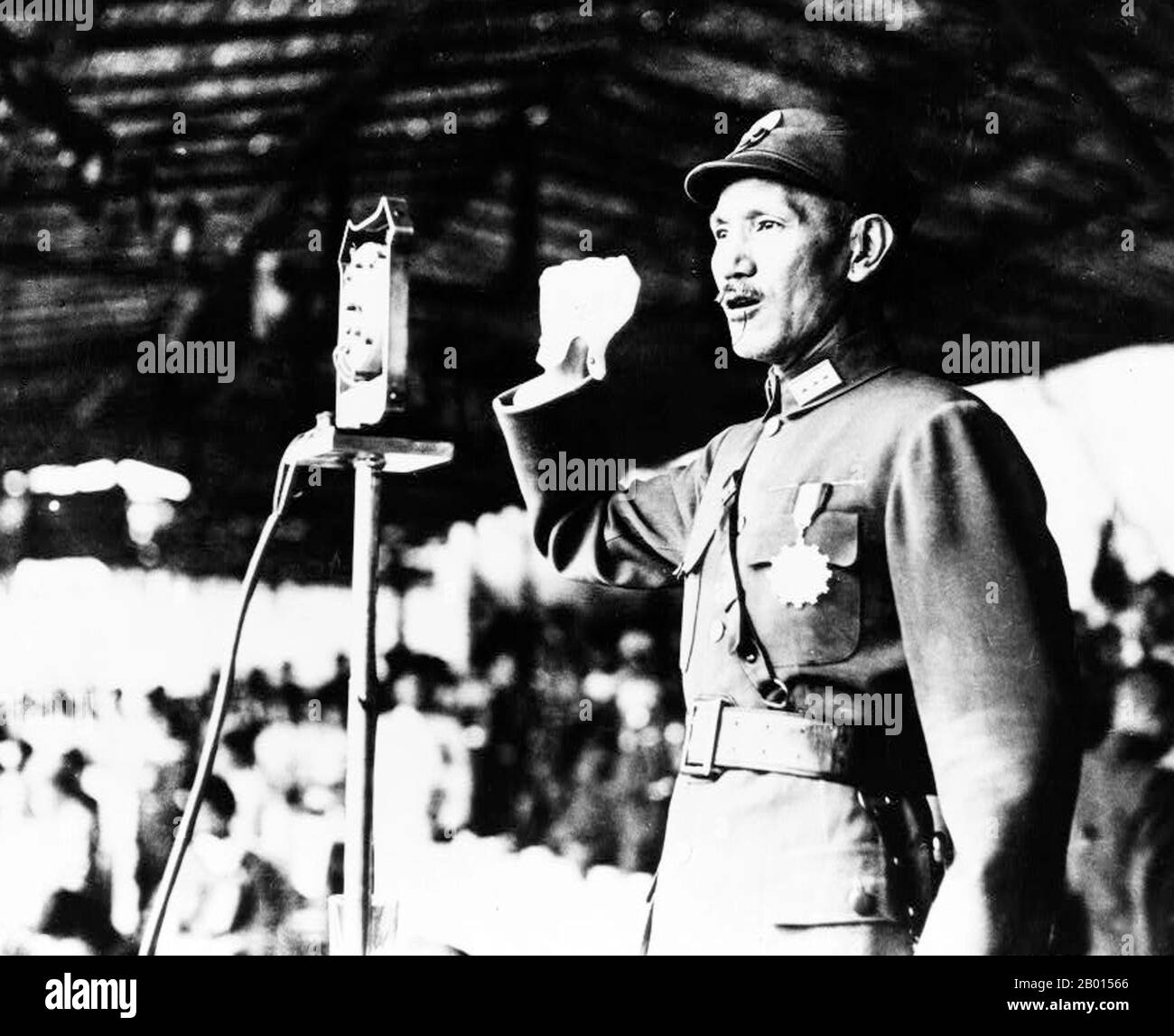 China: General Chiang Kai-shek addressing officer training corps at Hankou, 1940.  Chiang Kai-shek was a political and military leader of 20th century China. He is known as Jiǎng Jièshí or Jiǎng Zhōngzhèng in Mandarin. Chiang was an influential member of the Nationalist Party, the Kuomintang (KMT), and was a close ally of Sun Yat-sen. He became the Commandant of the Kuomintang's Whampoa Military Academy, and took Sun's place as leader of the KMT when Sun died in 1925. In 1926, Chiang led the Northern Expedition to unify the country. Stock Photo
