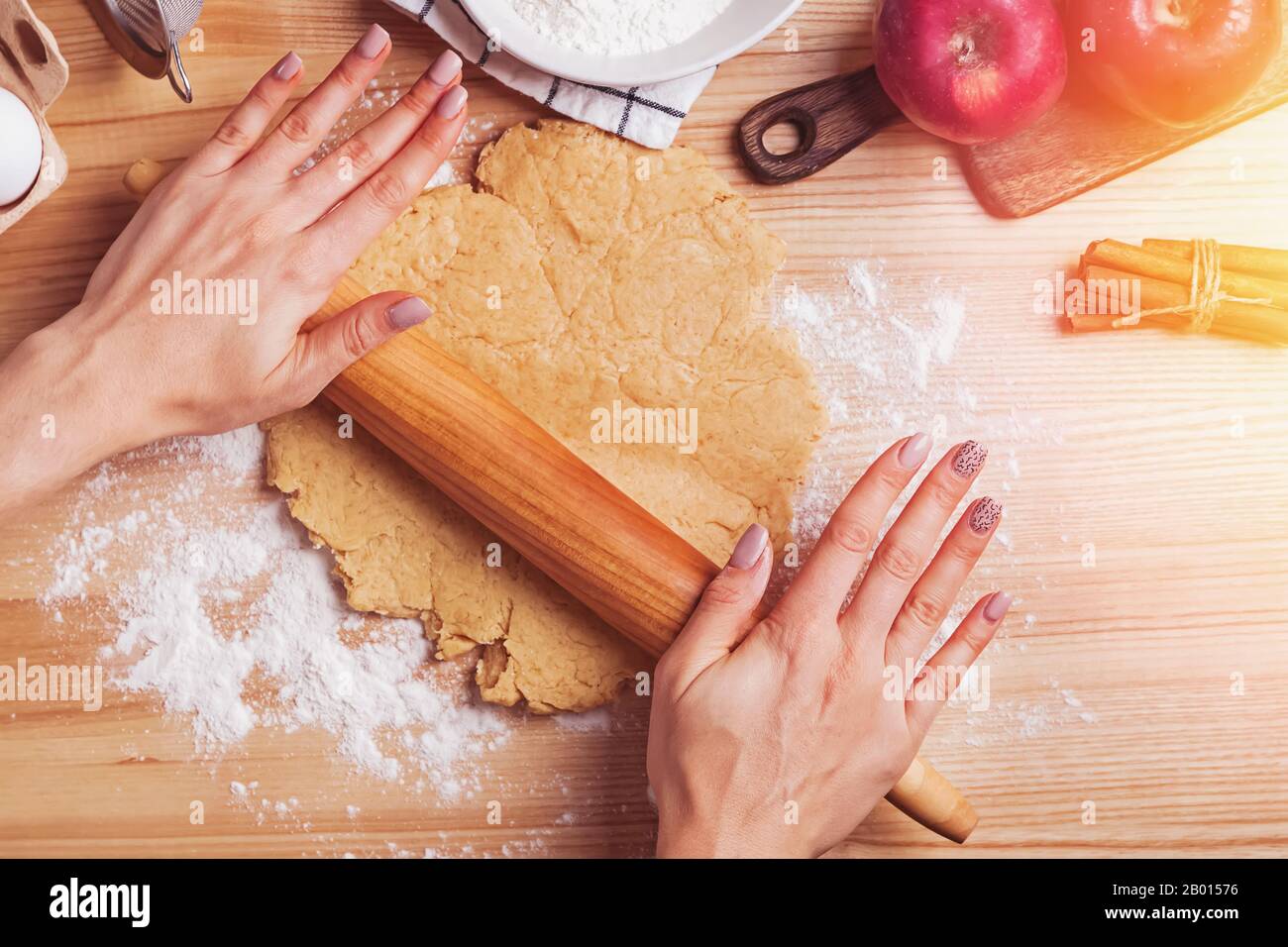 Woman's hands rolling dough for apple pie Stock Photo
