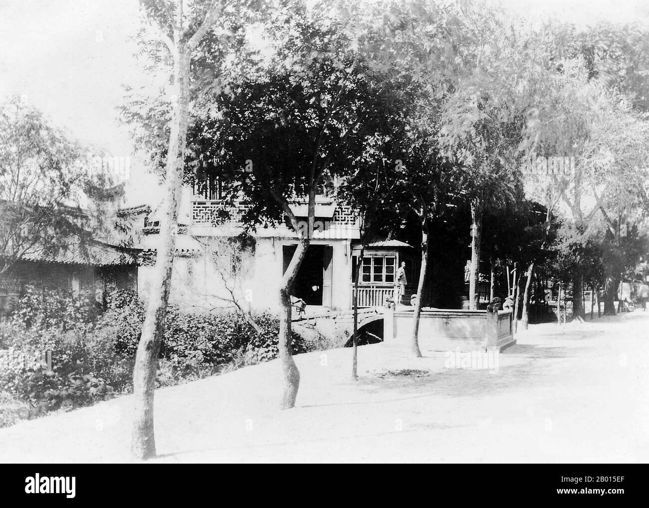 China: Shanghai's Jing'an Temple and the famous 'Bubbling Well', 1890.  Jing'an Temple, literally 'Temple of Peace and Tranquility', is a Buddhist temple on West Nanjing Road (formerly 'Bubbling Well Road.), in Jing'an District, Shanghai, China. The first temple was built in 247 CE, at the time of the Kingdom of Wu, during the Three Kingdoms period. Originally located beside Suzhou Creek, it was relocated to its current site in 1216 during the Song Dynasty. The current temple was rebuilt once in the Qing Dynasty. It has recently undergone further renovation. Stock Photo