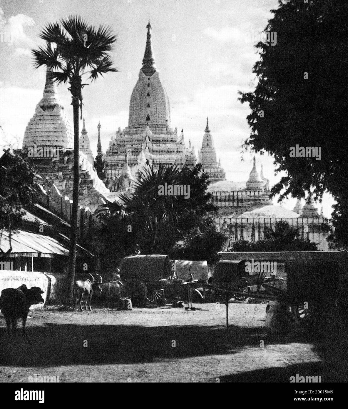 Burma/Myanmar: The Ananda Pagoda in Bagan, Upper Burma, c. 1920s.  Perhaps the highest revered temple in Bagan, the Ananda Pagoda was built in 1105 AD during the reign of King Kyanzittha (1084–1113) of the Bagan Dynasty. It is one of four surviving original temples of Bagan (also called Pagan). The temple layout is in a cruciform with several terraces leading to a small pagoda at the top covered by an umbrella (‘hti’).  The Buddhist temple houses four standing Buddhas—facing east, north, west and south. The temple is an architectural wonder with a fusion of Mon and adopted Indian styles. Stock Photo
