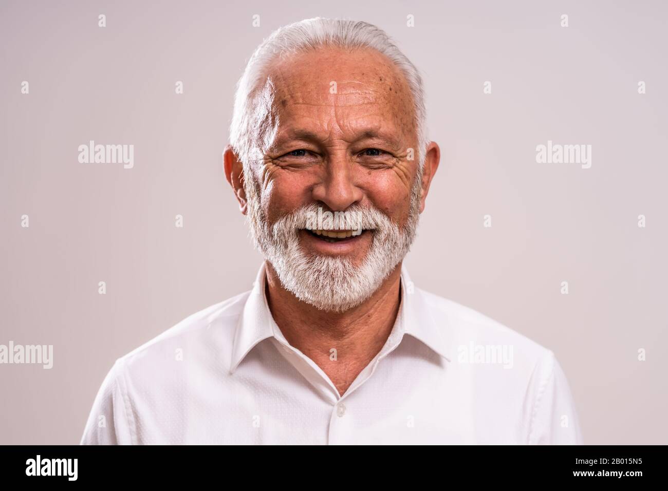 Portrait of cheerful senior man who is looking at camera and smiling ...