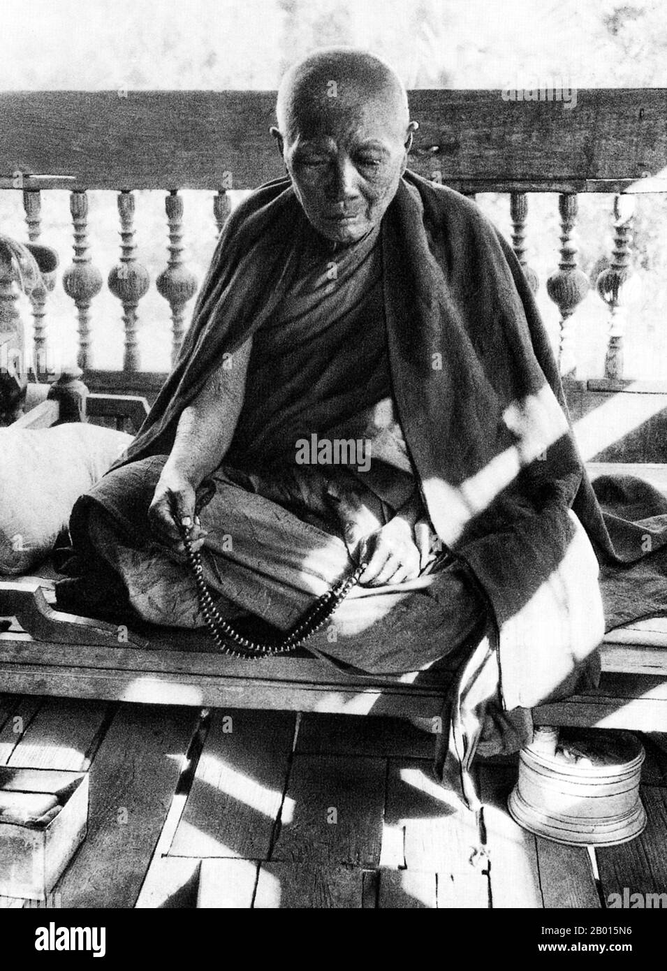 Burma/Myanmar: An old Buddhist monk with prayer beads, c. 1920s.  Legend attributes the first Buddhist doctrine in Burma to 228 BC when Sohn Uttar Sthavira, one of the royal monks to Emperor Ashoka the Great of India, came to the country with other monks and sacred texts. However, the era of Buddhism truly began in the 11th century after King Anawrahta of Pagan (Bagan) was converted to Theravada Buddhism. Today, 89% of the population of Burma is Theravada Buddhist. Stock Photo