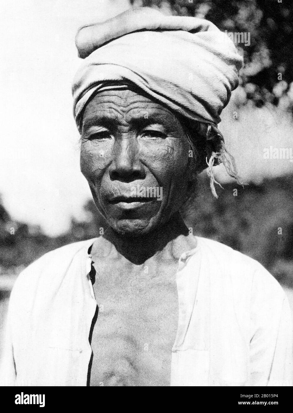 Burma/Myanmar: A village headman in a rural village in Upper Burma, c. 1920s.  The British conquest of Burma began in 1824 in response to a Burmese attempt to invade India. By 1886, and after two further wars, Britain had incorporated the entire country into the British Raj.  To stimulate trade and facilitate changes, the British brought in Indians and Chinese, who quickly displaced the Burmese in urban areas. To this day Rangoon and Mandalay have large ethnic Indian populations. Railways and schools were built, as well as a large number of prisons, including the infamous Insein Prison. Stock Photo