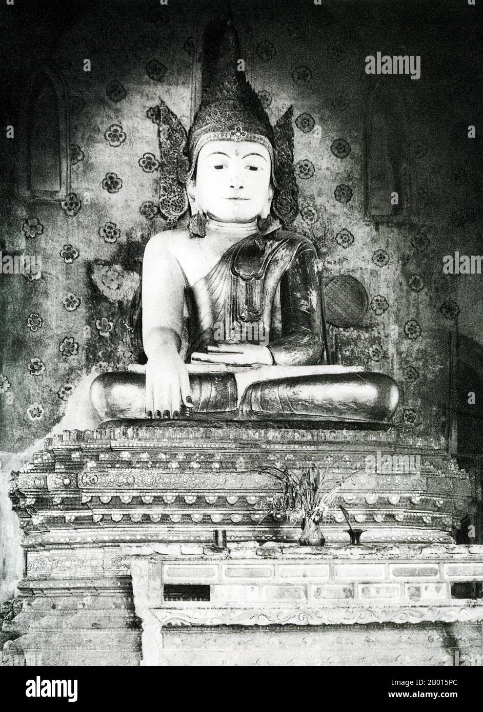 Burma/Myanmar: A Buddha statue in a temple near Ava, Upper Burma, c. 1920s.  Ava was capital of Burma from 1364 to 1841 and was founded by King Thadominbya on an artificial island at the confluence of the Irrawaddy and the Myitnge created by digging a canal linking the two rivers. Prior to this, Sagaing had been capital, but after Sagaing fell to the Shan, the court moved across the river to Ava.  The culture of Pagan was revived and a great age of Burmese literature ensued. The kingdom lacked easily defensible borders, however, and was overrun by the Shan in 1527. Stock Photo