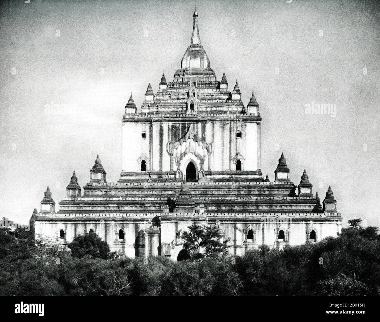 Burma/Myanmar: Thatbyinnyu Pagoda in Bagan, Upper Burma, c. 1920s.  The 61 m-high Thatbyinnyu temple was built as a Buddhist monastery (vihara) in 1144 during the reign of King Alaungsithu. It is adjacent to Ananda Temple. Thatbyinnyu Temple is shaped like a cross, but is not symmetrical. The temple has two primary storeys, with the seated Buddha image located on the second storey.  The ruins of Bagan/Pagan cover an area of 16 square miles (41 km2). The majority of its buildings were built between the 11th and 13th centuries, during the time Bagan was the capital of the First Burmese Empire. Stock Photo