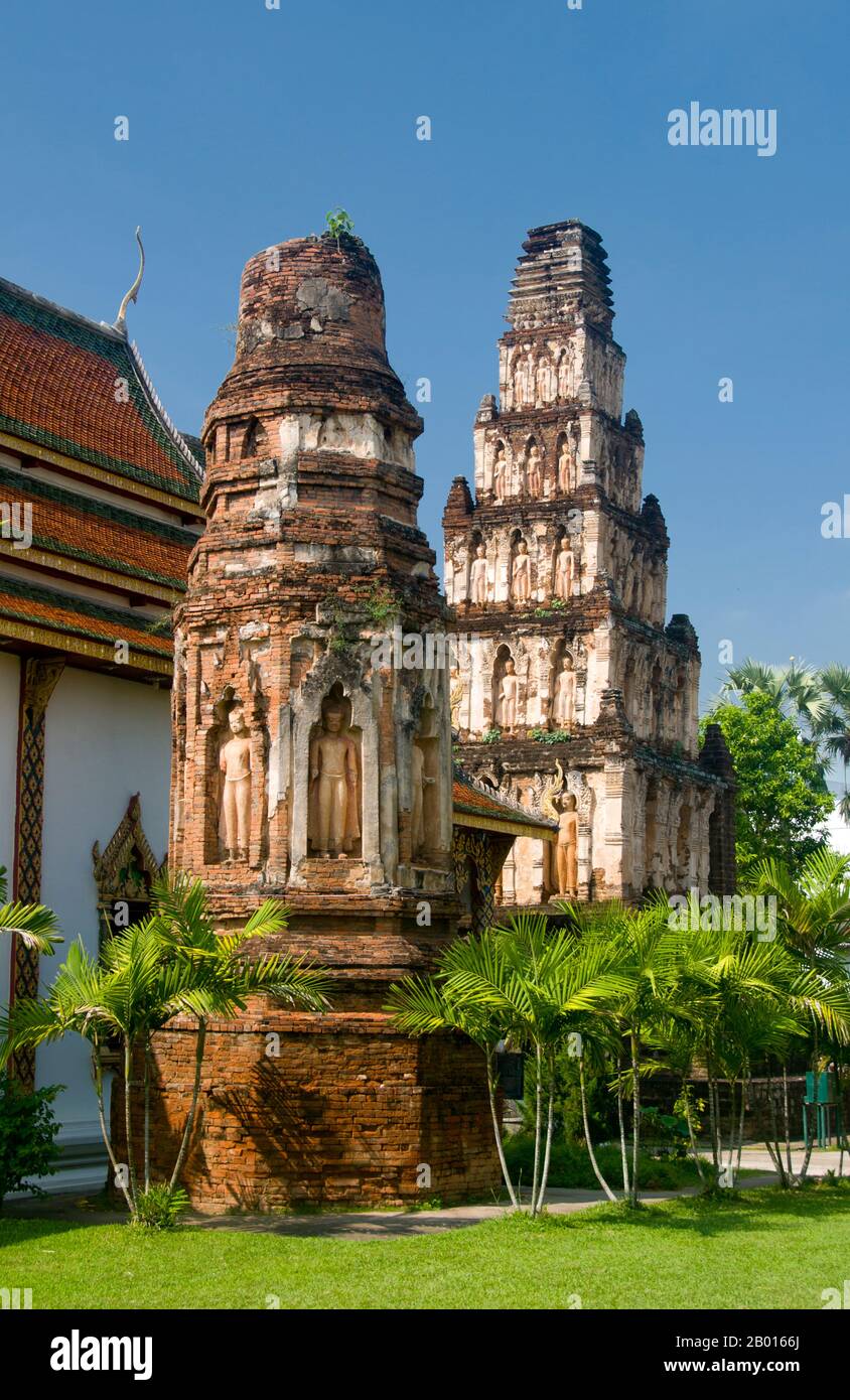 Thailand: The Ratana Chedi and the Chedi Suwanna Chang Kot (or Mahapon Chedi), Wat Chama Thewi, Lamphun.  Wat Chamathewi (Chama Thewi or Chamadevi) or Wat Kukut (Temple of the Broken Reliquary) as it is also known, was built at some point in the 8th or 9th century. It contains two authentic Mon chedi. The first and larger of these is the Mahapon Chedi or ‘Great Victory Stupa’, also known as Chedi Suwanna Chang Kot or ‘Heavenly Stupa with a Magnificent Summit’, a tall structure of laterite and stucco set on a square laterite foundation. Stock Photo
