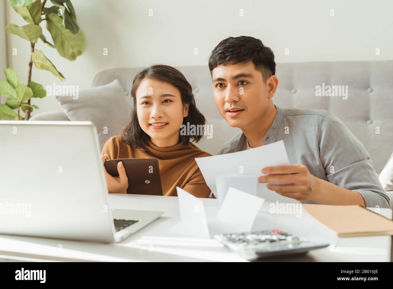 Young family discussing family finances Stock Photo