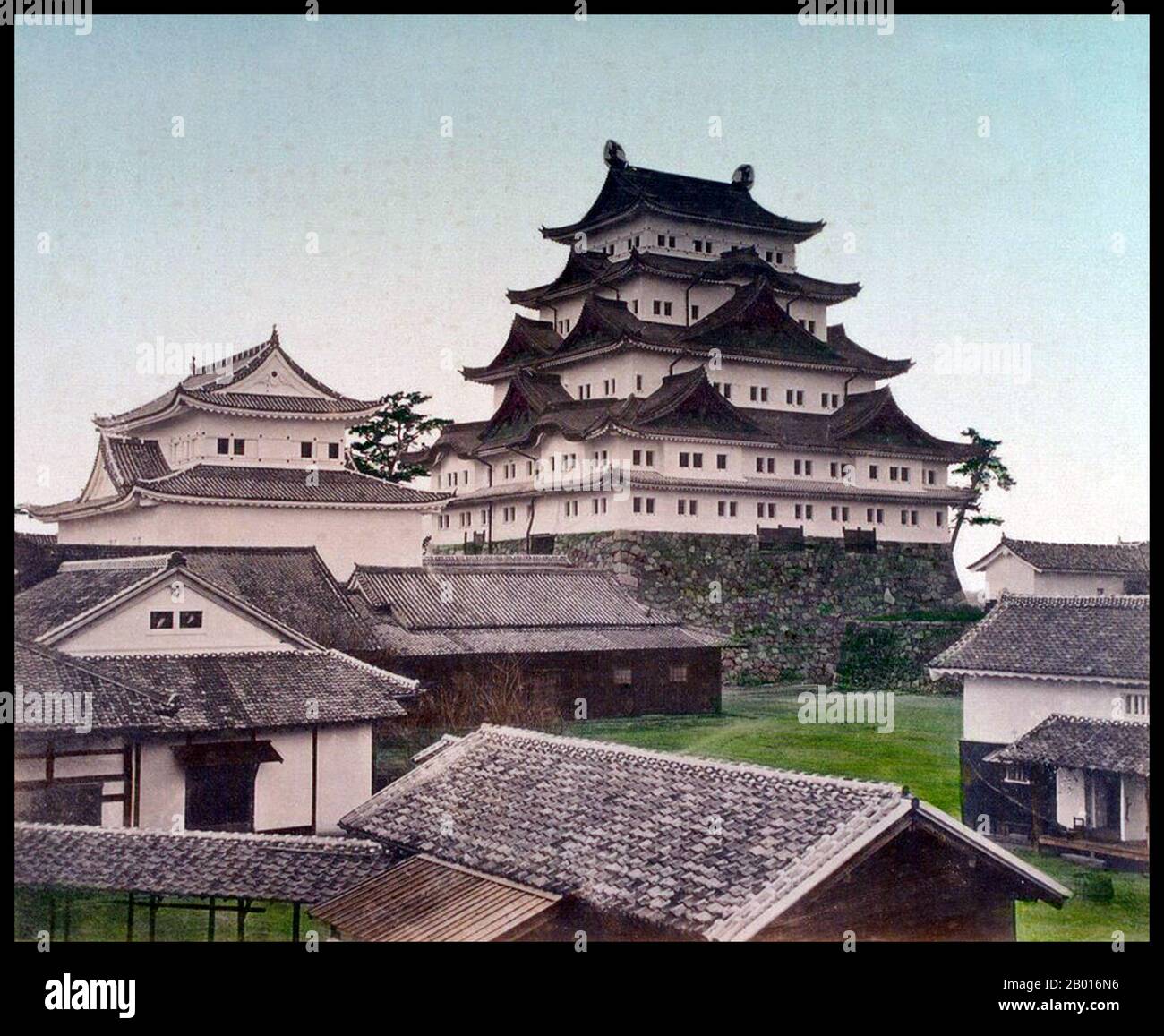 Japan: Nagoya Castle. Photograph by Tamamura Kozaburo (1856-1923), c. 1879.  Nagoya Castle (Nagoya-jō) is a castle located in Nagoya, central Japan. It was built by the Owari Domain in 1612. During the Edo period, Nagoya Castle was the centre of one of the most important castle towns in Japan—Nagoya-juku— and it included the most significant stops along the Minoji, which linked the Tōkaidō with the Nakasendō (major national highways). Stock Photo