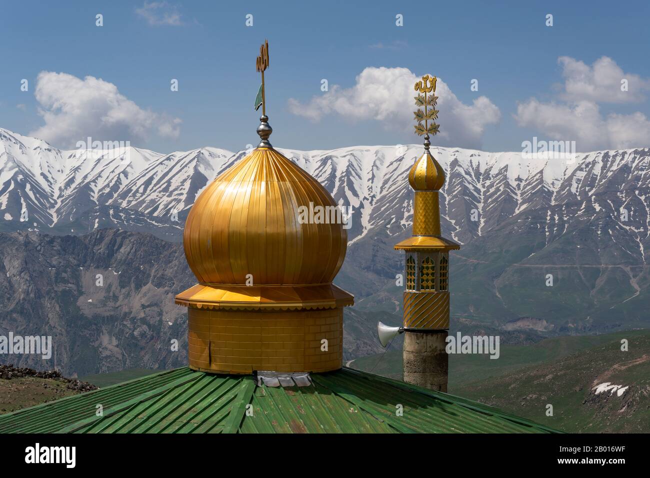 Base camp of Mount Damavand with mountains and snow and golden roof of mosque. Stock Photo