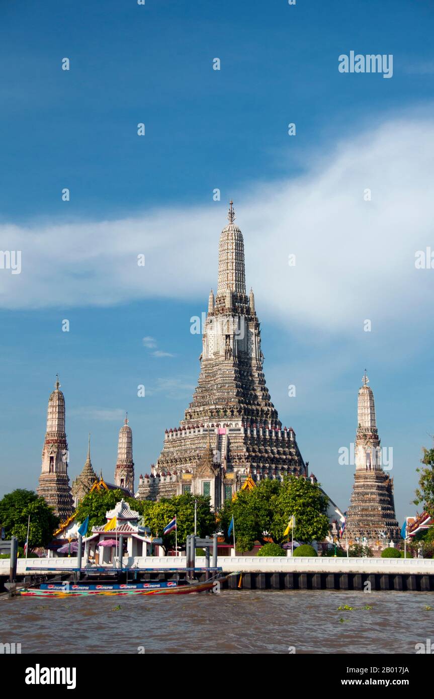 Thailand: Wat Arun (Temple of Dawn) from the Chao Phraya River, Bangkok.  Wat Arun Rajwararam (Temple of the Dawn), full name Wat Arunratchawararam Ratchaworamahawihan, is a Thai Buddhist temple on the Thonburi west bank side of the Chao Phraya River in Bangkok. It is named after Aruna, the Indian God of Dawn. A monastery has stood here since the Ayutthayan period (1351 - 1767), but the temple's outstanding feature, the Khmer-style central prang, was not begun until 1809, during the reign of King Buddha Loetla Nabhalai (Rama II). Stock Photo